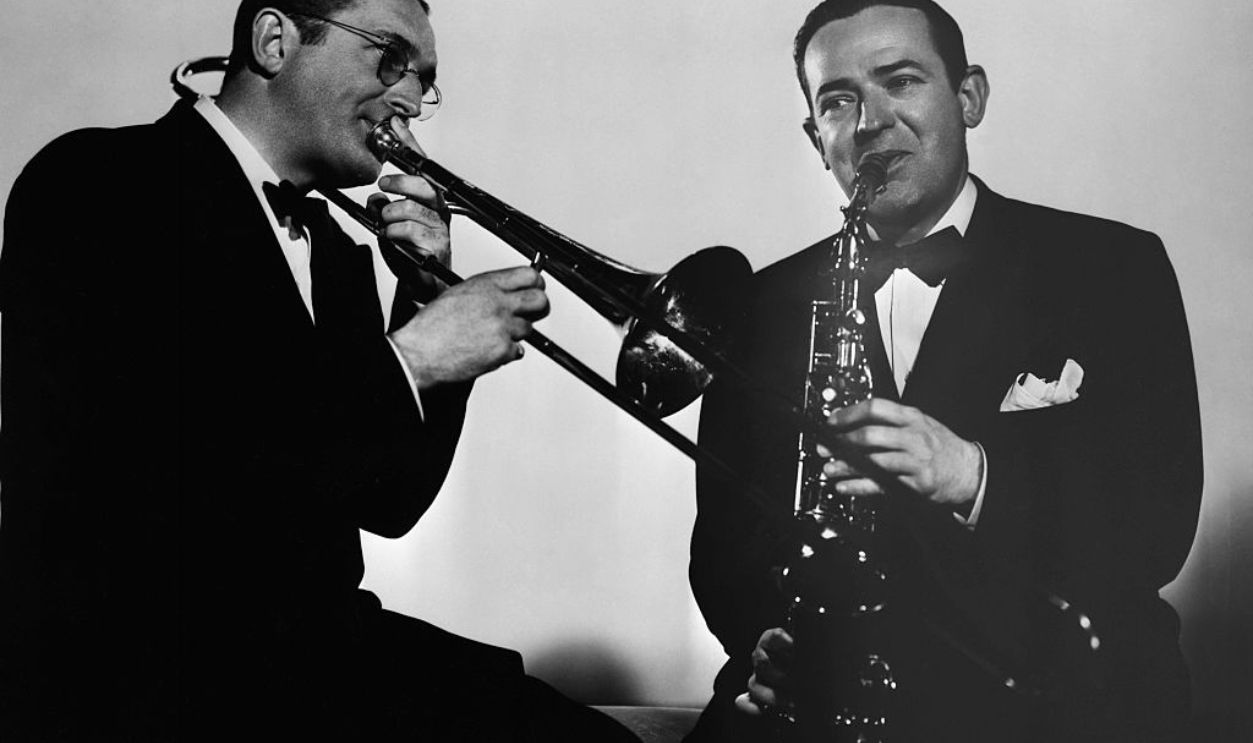 (Original Caption) Tommy Dorsey playing the trombone and Jimmy Dorsey playing the saxophone. Seated photograph. Movie still from 