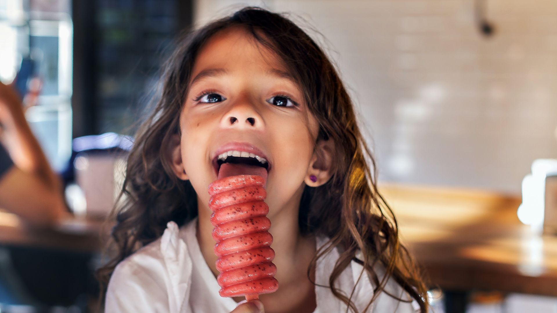 girl licking popsicle