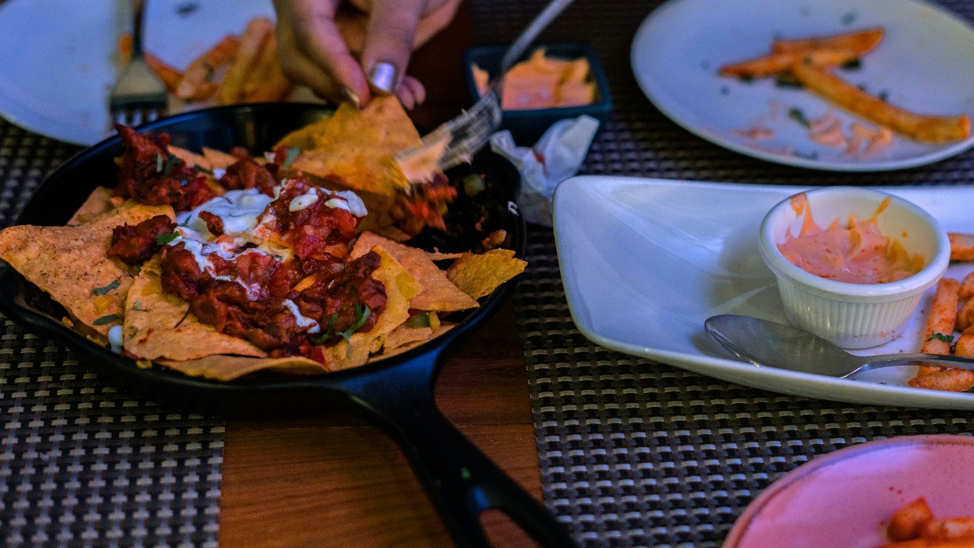 a person cutting up food on a plate