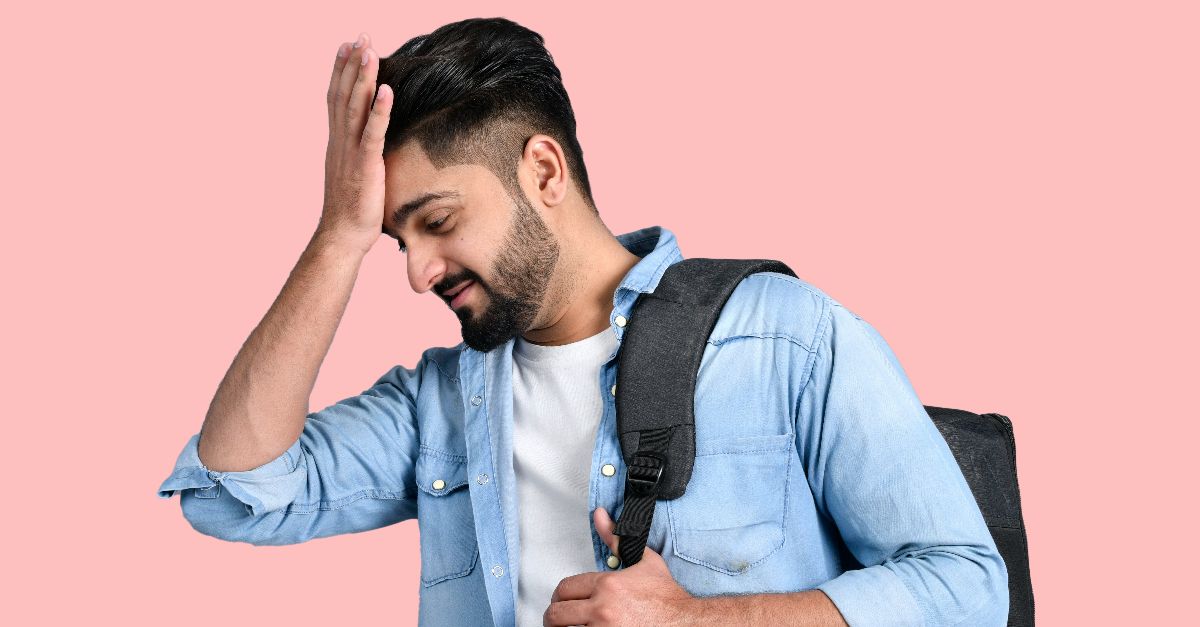 a man with his hand on his head