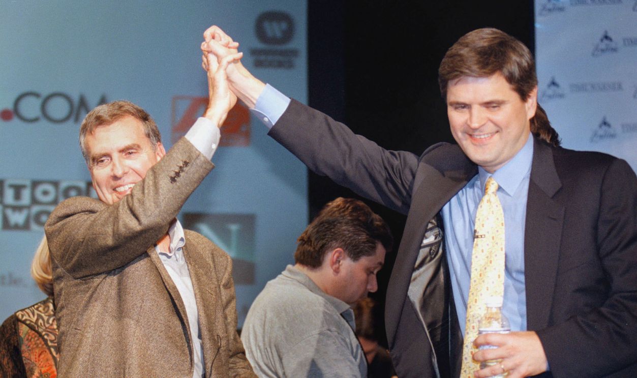  Time Warner Chairman and CEO Gerald Levin, left, and America Online Chairman and CEO Steve Case give a high five January 10, 2000 in New York City after announcing that AOL was acquiring Time Warner for $166 billion in stock. On January 11, 2001, one year and one day after the original announcement, the Federal Communications Commission announced its conditional approval of the multibillion-dollar merger, clearing the way for the deal to go through. 