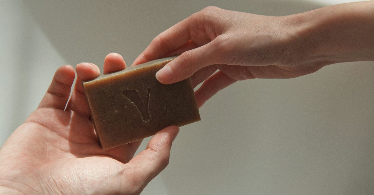 person holding brown wooden box