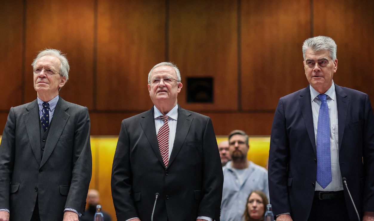 Former CEO of German carmaker Volkswagen (VW) Martin Winterkorn (C) and his lawyers Kersten von Schenck (L) and Felix Doerr wait for the start of a resumed trial for market manipulation, on February 14, 2024 in Braunschweig, northern Germany. Under the reinstated charges, Winterkorn is accused of having intentionally failed to inform financial markets in time of the risk of a fine due to emissions-cheating vehicles on the US market. The Volkswagen group was plunged into crisis in 2015 when it admitted to installing cheating software in millions of diesel vehicles worldwide to dupe pollution tests. 