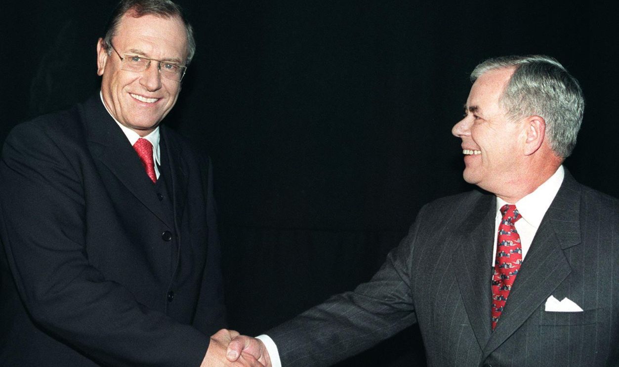 Daimler-Benz chairman Juergen Schrempp (left) and Chrysler chairman Robert Eaton shake hands before giving a press conference in London 07 May. They announced that the German Daimler-Benz company and US car maker Chrysler would merge and be worth 166 billion German marks (92 billion dollars) to spawn one of the world's top three automakers. The planned mega-merger with Chrysler Corporation was unlikely to throw up competitive problems. 