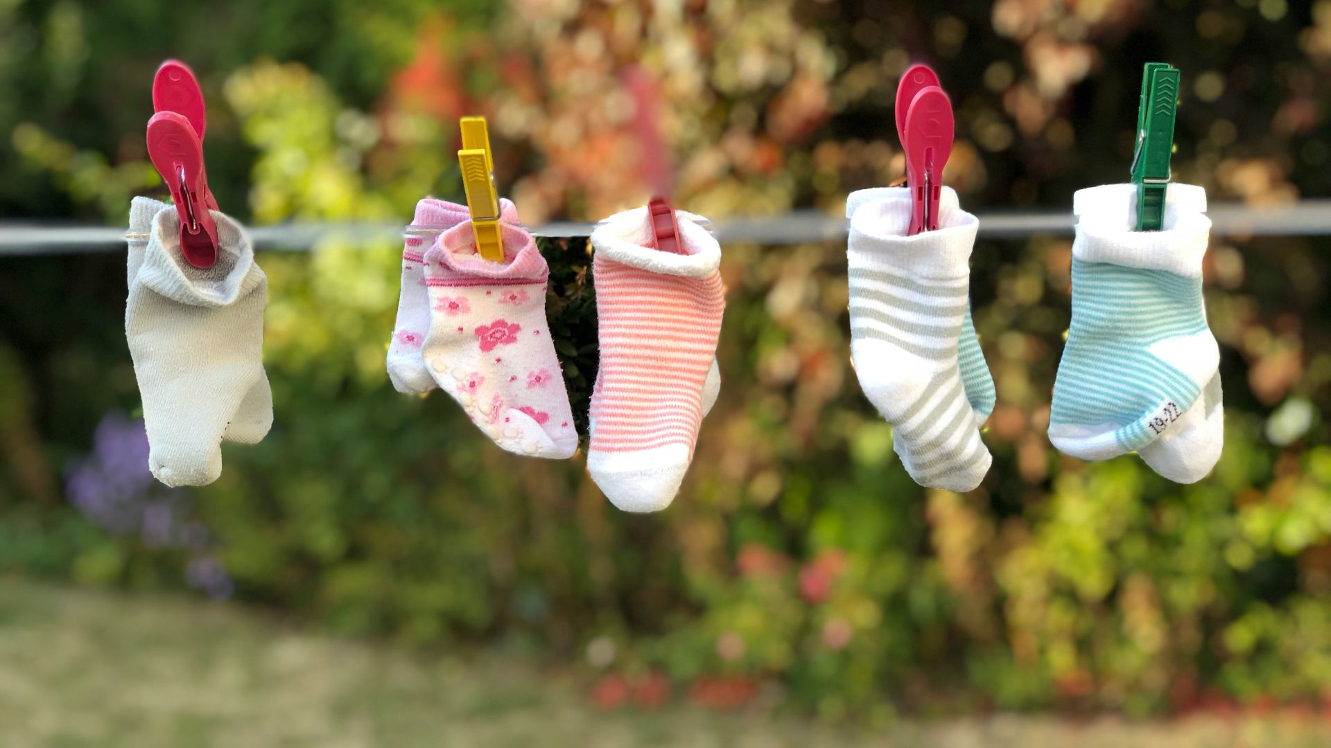 five pairs of socks pinned on clothesline