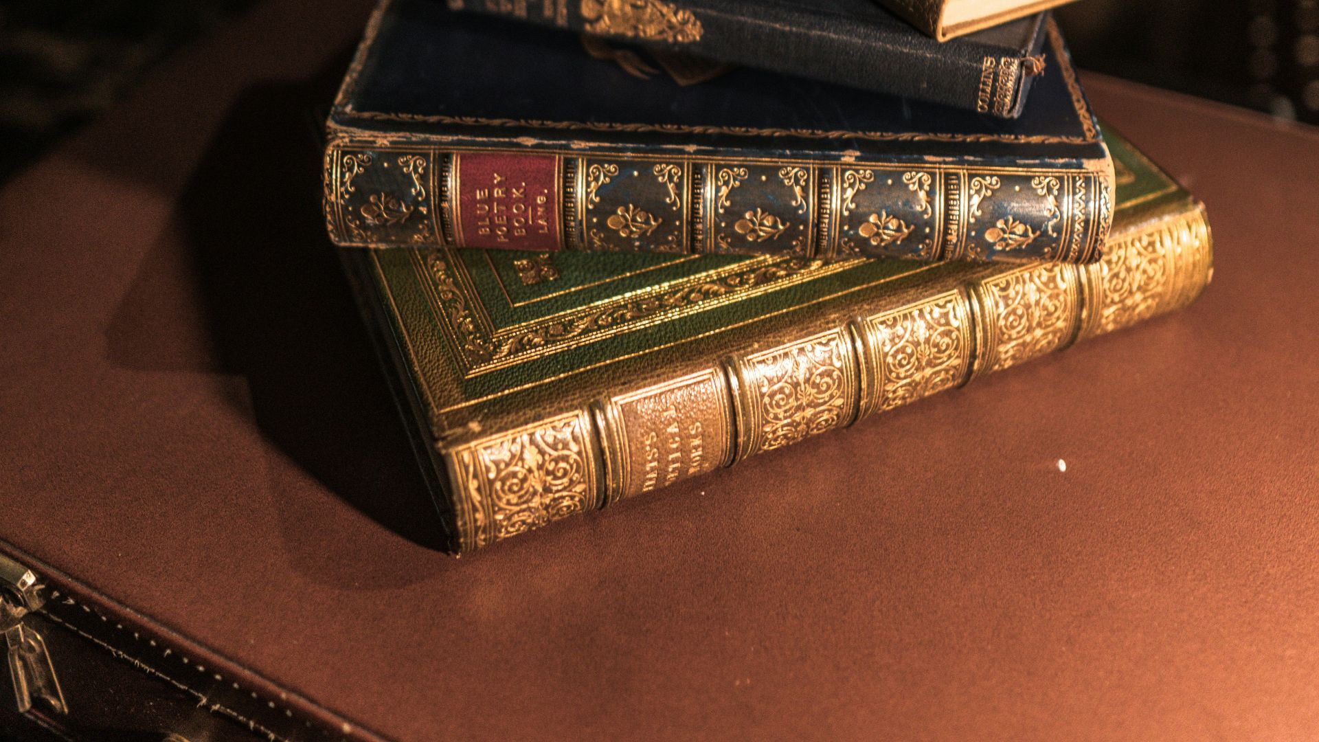 brown hardbound book on brown wooden table
