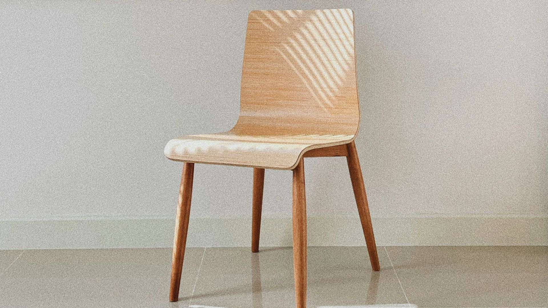 brown wooden chair beside white wall
