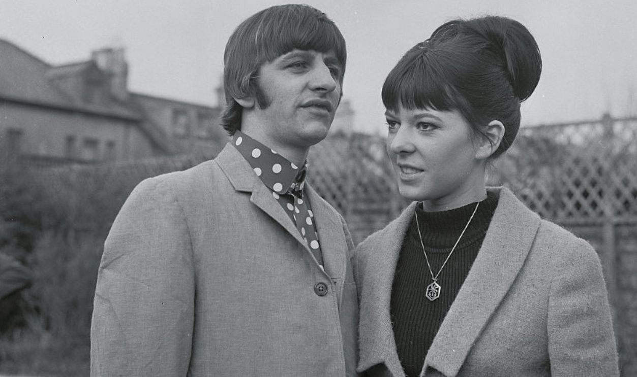 (Original Caption) Hove, Sussex, England: Put Their Heads Together. Beatle drummer Ringo Starr and his bride, the former Maureen Cox, put their heads together outside their honeymoon haven here February 12th. They were married in London, February 11th.