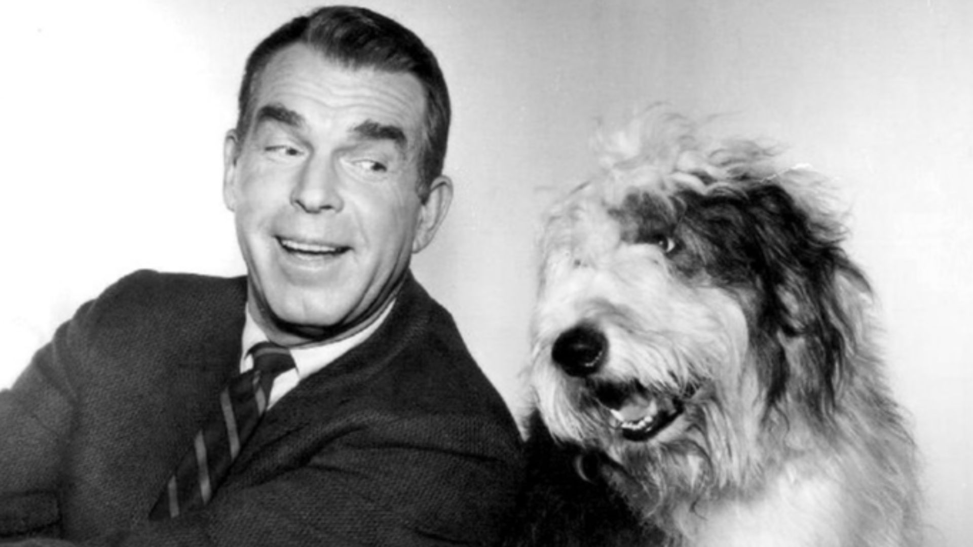 Photo of Fred MacMurray as Steve Douglas with Tramp, the Douglas family dog, from My Three Sons.