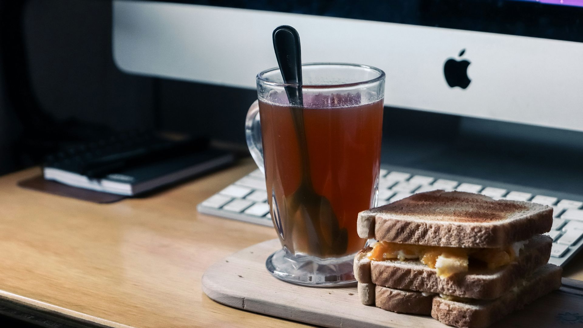 a cup of tea and a sandwich on a desk