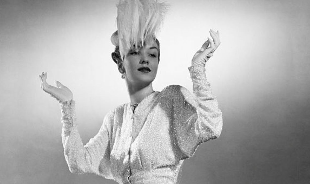 (Original Caption) 11/1/1945-New York, New York-This exquisite, snow-white, crepe dinner suit, frosted with icicles of bugle beads is Kiviette at her wonderful best. The costume was inspired by one worn by June Haver, who plays the part of one of the famous sisters in 