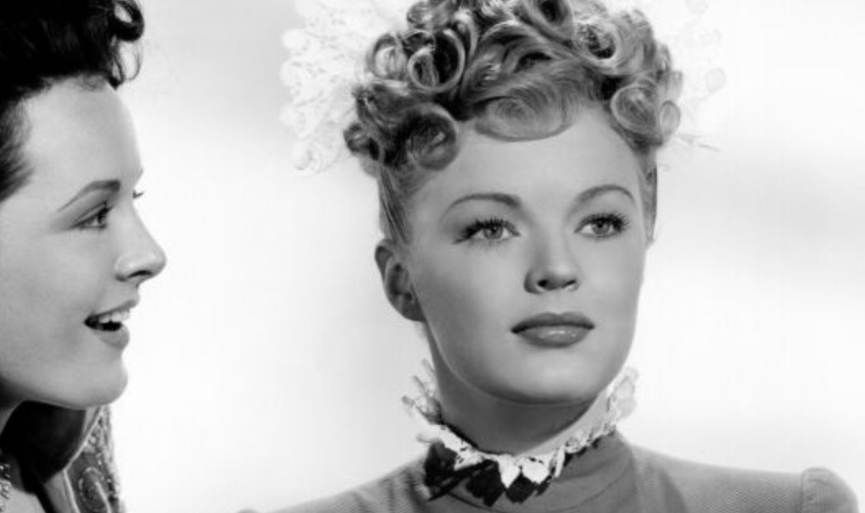 Lenore Aubert (1918-1993) as 'Fritzi Barrington' and June Haver (1926-2005) as 'Katie McCullem' in a publicity shot from the movie 'I wonder Who's Kissing Her Now', 1947, United States. 