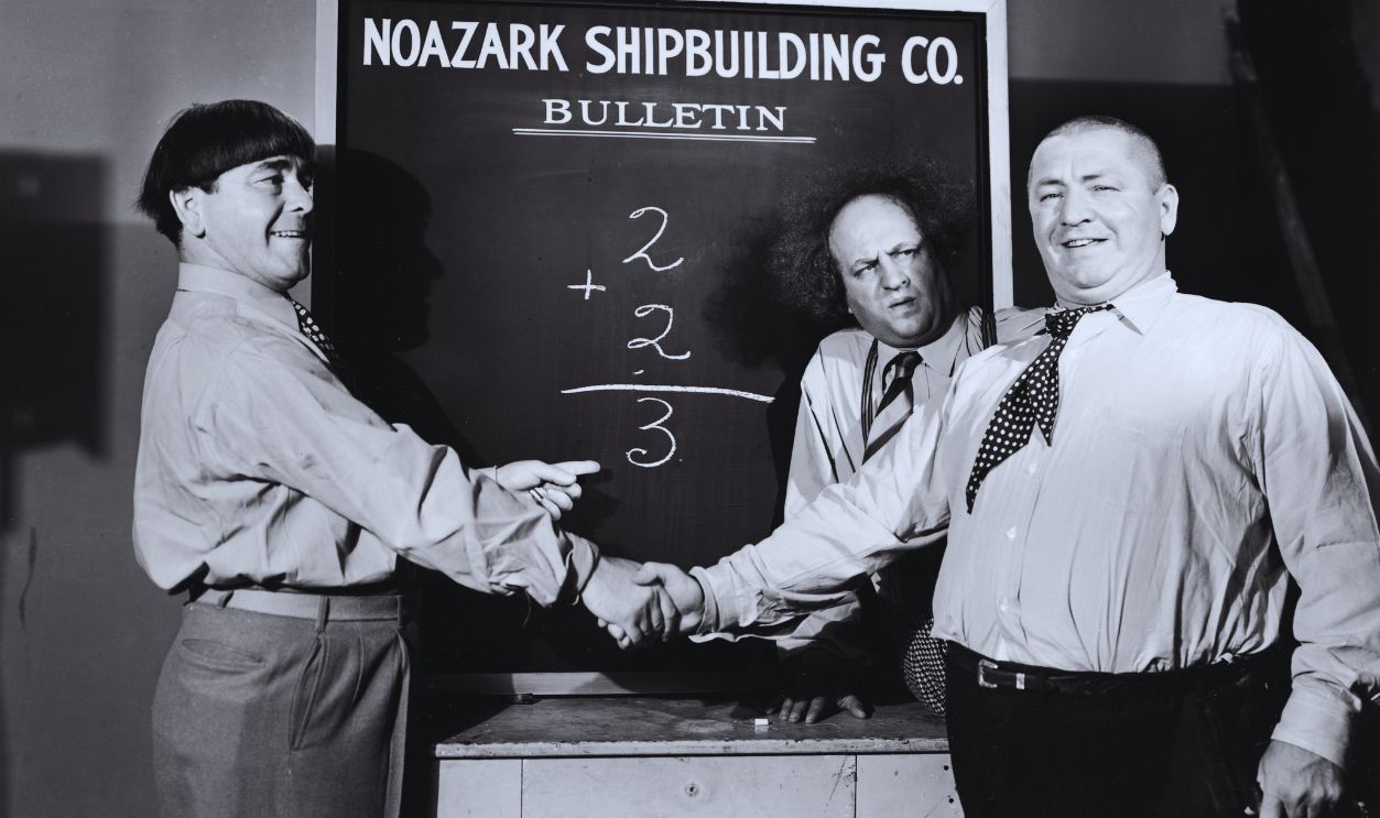 Gettyimages - 51309234, 'The Three Stooges' American actors Moe Howard (1897 - 1975) and Curly Howard (1903 - 1952) shake hands as Larry Fine (1902 - 1975) looks on in a still from an unidentified Three Stooges film.
