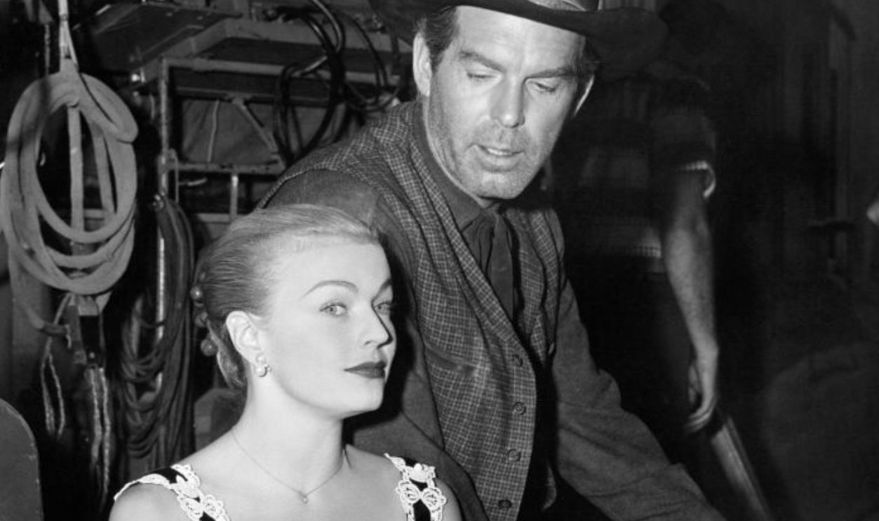June Haver and Fred MacMurray sitting on the set of the film 'Quantez', 1957. 