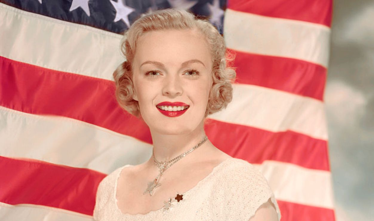 June Haver poses by the American Flag circa 1945. 