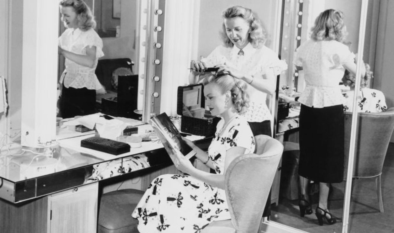American actress June Haver (1926 - 2005) has her hair done by a studio stylist, circa 1950.