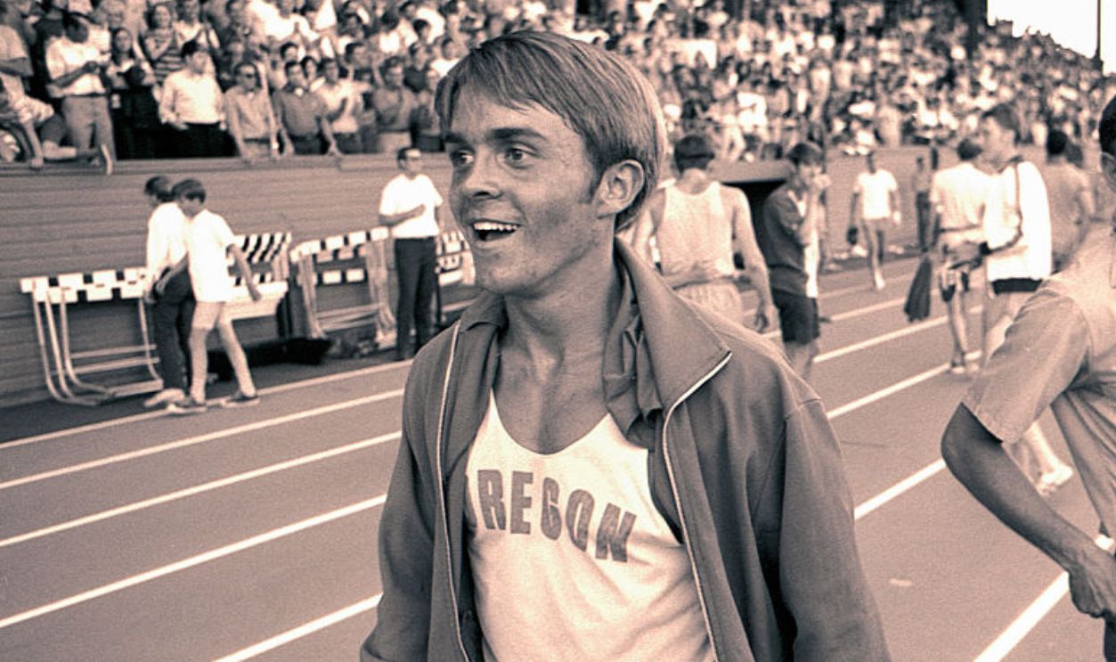 EUGENE, OREGON - JUNE 1970: University of Oregon distance runner Steve Prefontaine smiles while walking in front of the grandstands of the university's Hayward Field surrounding a race in June of 1970 in Eugene, Oregon. Prefontaine later set the American record for the 5,000 meters at the 1972 Olympic Trials and competed in the 1972 Olympic Games in Munich, Germany. He died in a tragic single-car auto accident in 1975.