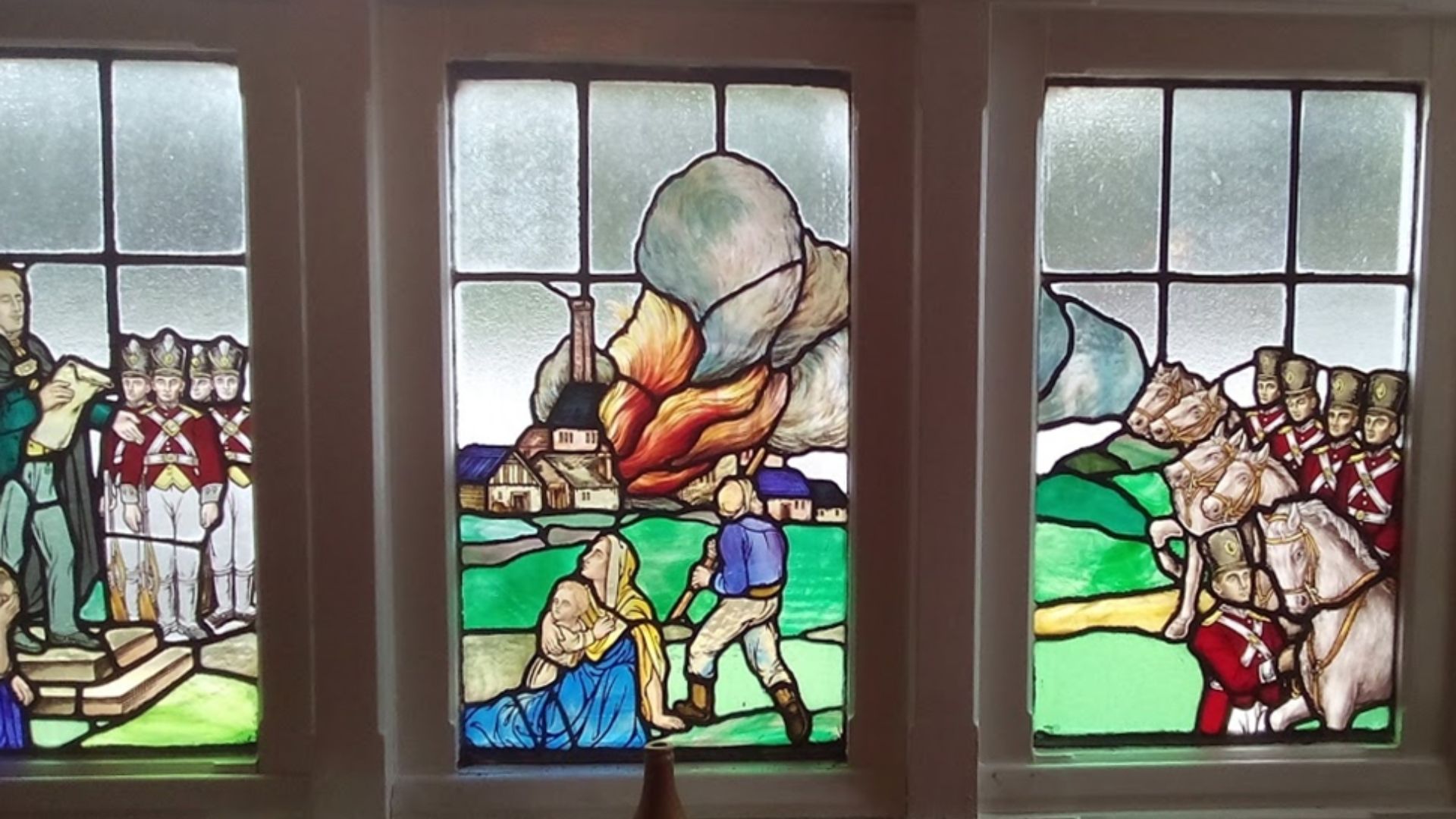 Stained glass window in the Windmill public house, Westhoughton representing the Luddite attack on Westhoughton Mill.