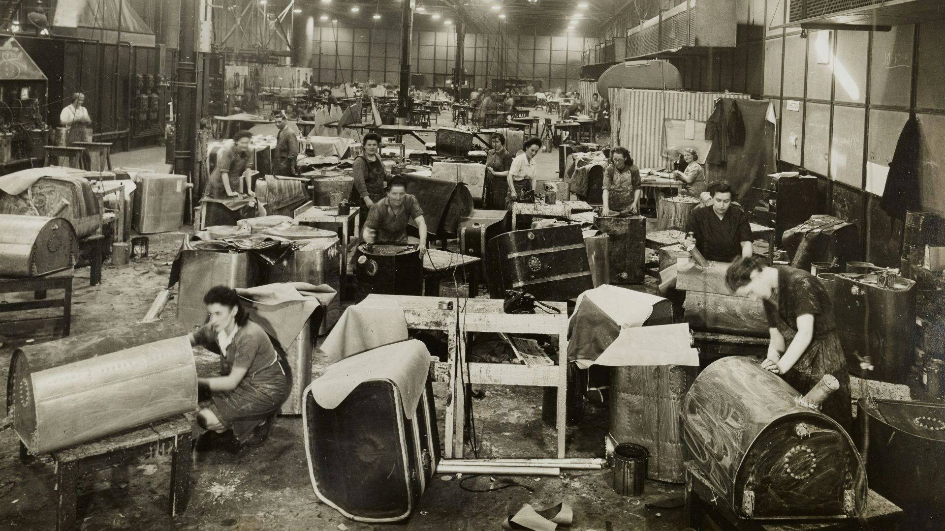 grayscale photo of people sitting on chair