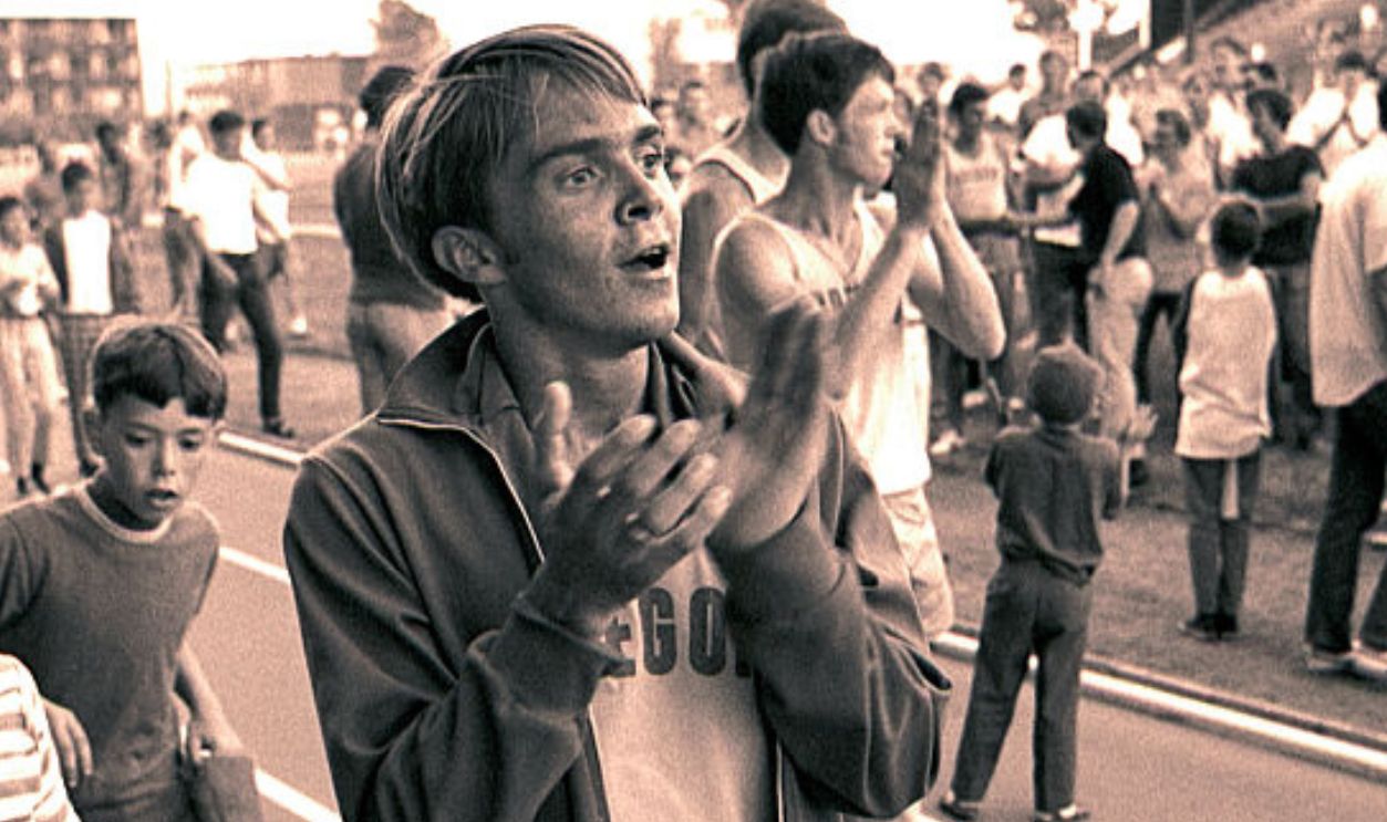 EUGENE, OREGON - JUNE 1970: University of Oregon distance runner Steve Prefontaine is followed by some young autograph-seekers surrounding a race at the university's Hayward Field in Eugene, Oregon in June of 1970. Prefontaine later set the American record for the 5,000 meters at the 1972 Olympic Trials and competed in the 1972 Olympic Games in Munich, Germany. He died in a tragic single-car auto accident in 1975.