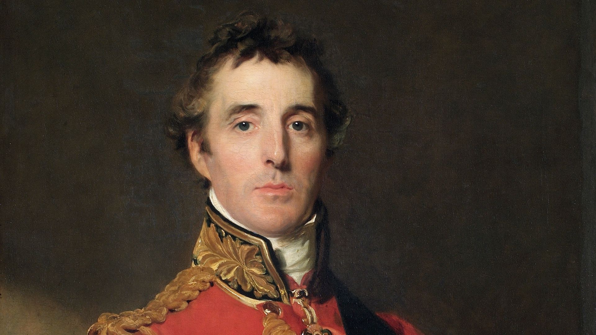 The Duke of Wellington is standing at half-length, wearing Field Marshal’s uniform, with the Garter star and sash, the badge of the Golden Fleece, and a special badge ordered by the Prince Regent to be worn from 1815 by Knights Grand Cross of the Military