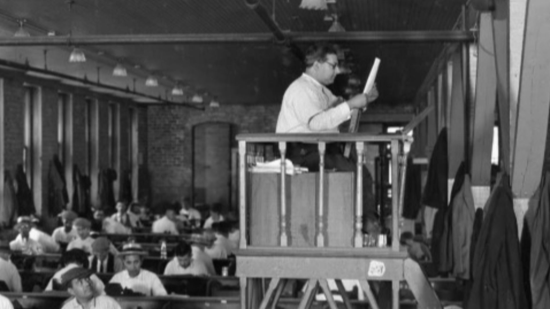 Interior view of the Cuesta-Rey Cigar Company - Tampa, Florida. Lector in a large cigar factory: Tampa, Florida (1929)
Note the lector reading from the raised platform at the right. Historically, lectors or readers in a cigar factory entertained workers b
