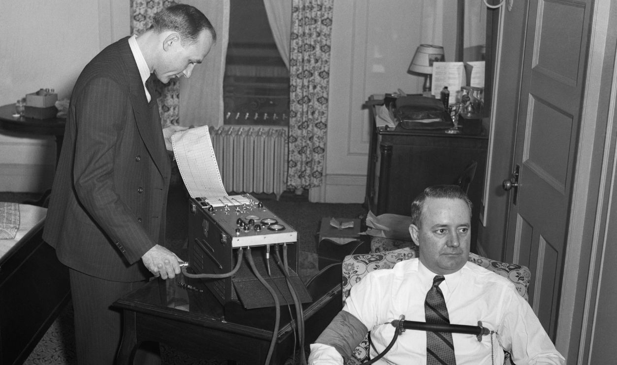 E.A. Wildy (left), of the Treasury Secret Service, gives a demonstration of Uncle Sam's latest lie detector, using M.R. Allen, secret service agent in charge of Washington, as his subject, before the United States Secret Service Men's convention here.