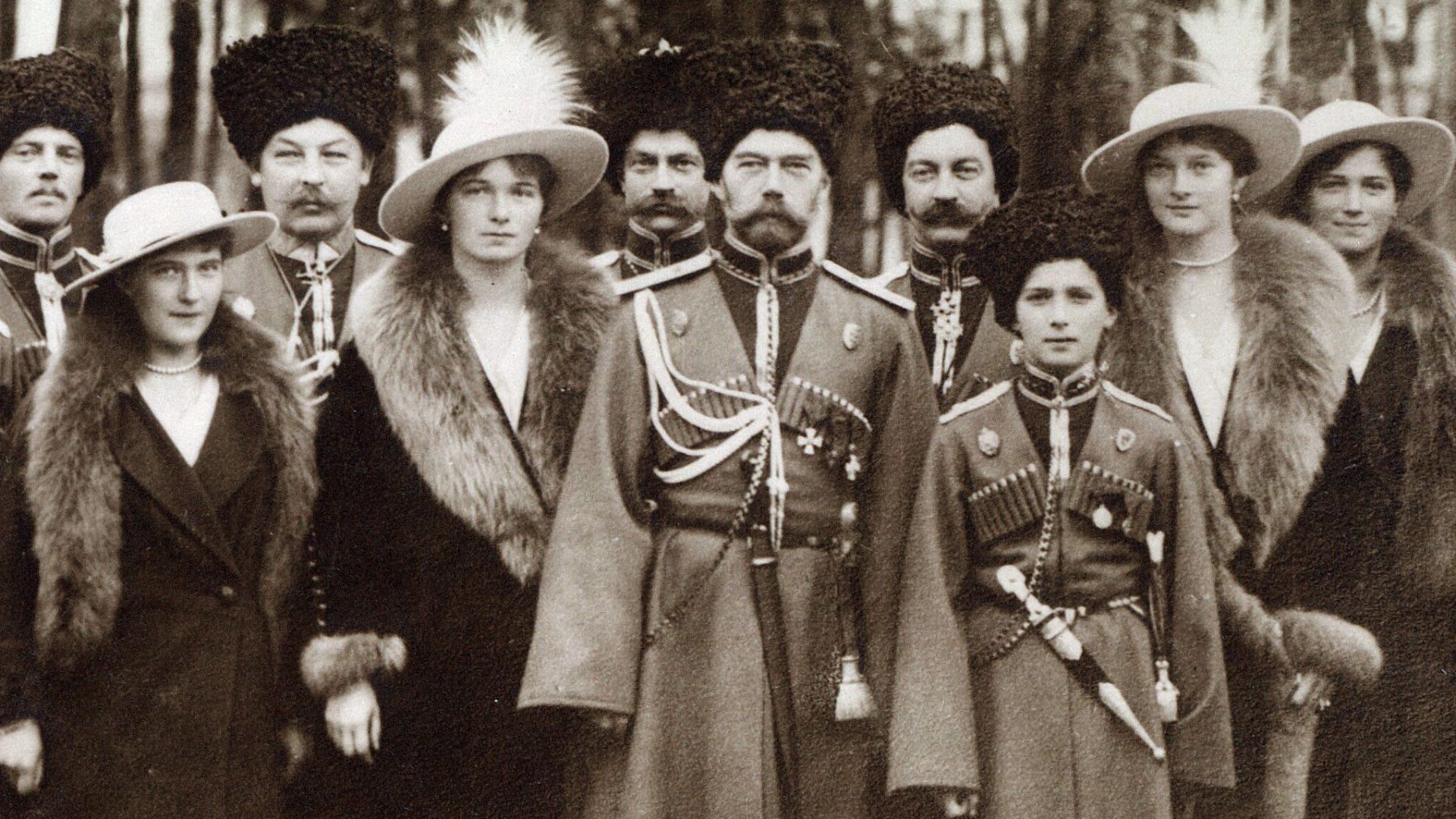 It is of Tsar Nicholas II and his family inspecting the troops in Russia in about 1916.Original description: The Emperor and his children with Cossack officers of the Konvoy (Grabbe, their commandant is seen between Anastasia and Olga) at GHQ Moginav (Mog