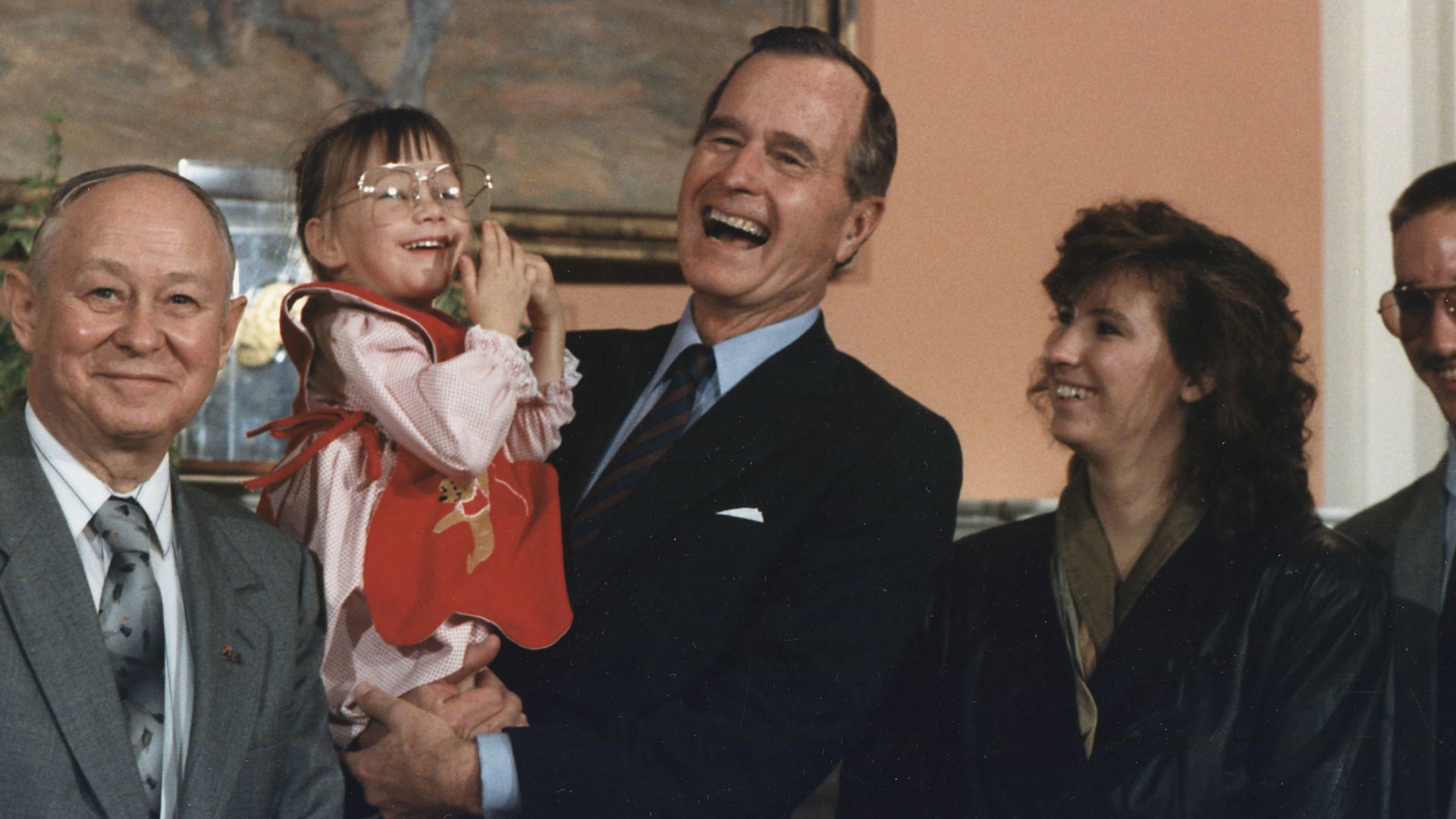 President Bush holds Jessica McClure during the Midland Community Spirit Award Presentation in the Roosevelt Room at the White House. The award was established by the town of Midland, TX and awarded to Sioux City, IA in recognition of the community's resp