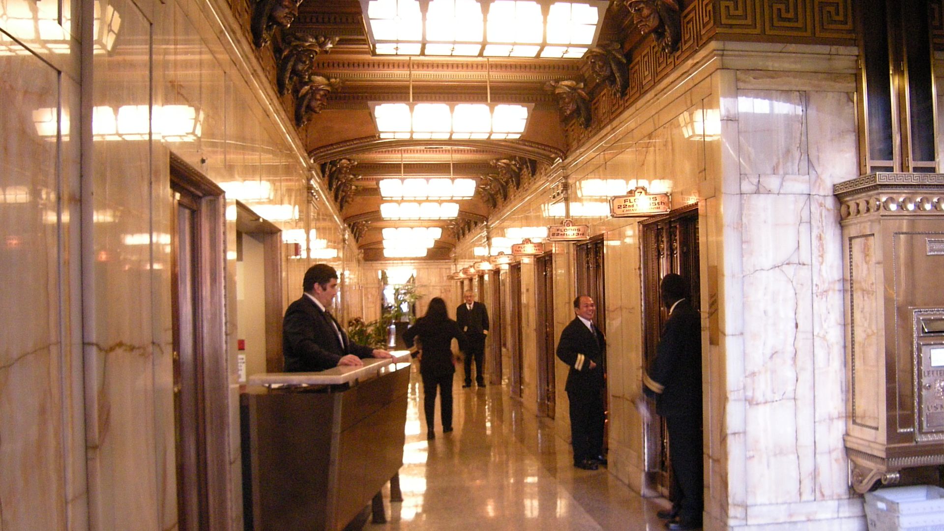 Lobby of the Smith Tower, Seattle, Washington, USA. Note the Indian head sculptures above the elevator doors. The Smith Tower is one of the last buildings in Seattle to use elevator operators rather than self-service elevators.