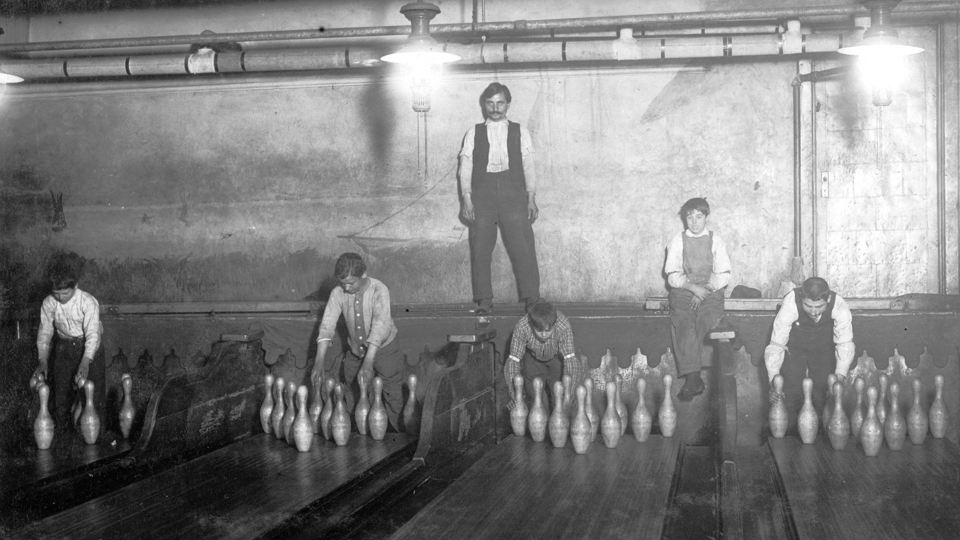 1:00 A.M. Pin boys working in Subway Bowling Alleys, 65 South St., B'klyn, N.Y. every night. 3 smaller boys were kept out of the photo by Boss. Location: New York--Brooklyn, New York (State).