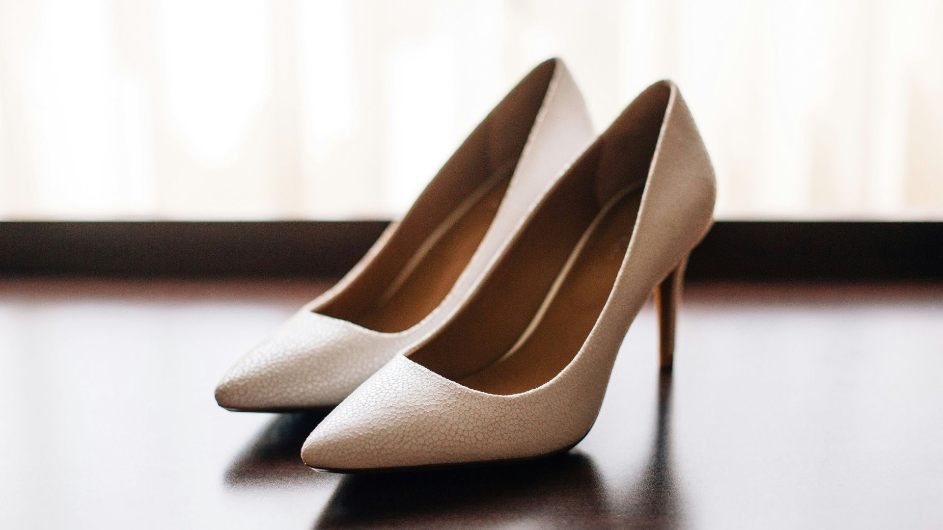pair of women's brown pointed-toe pumps on board