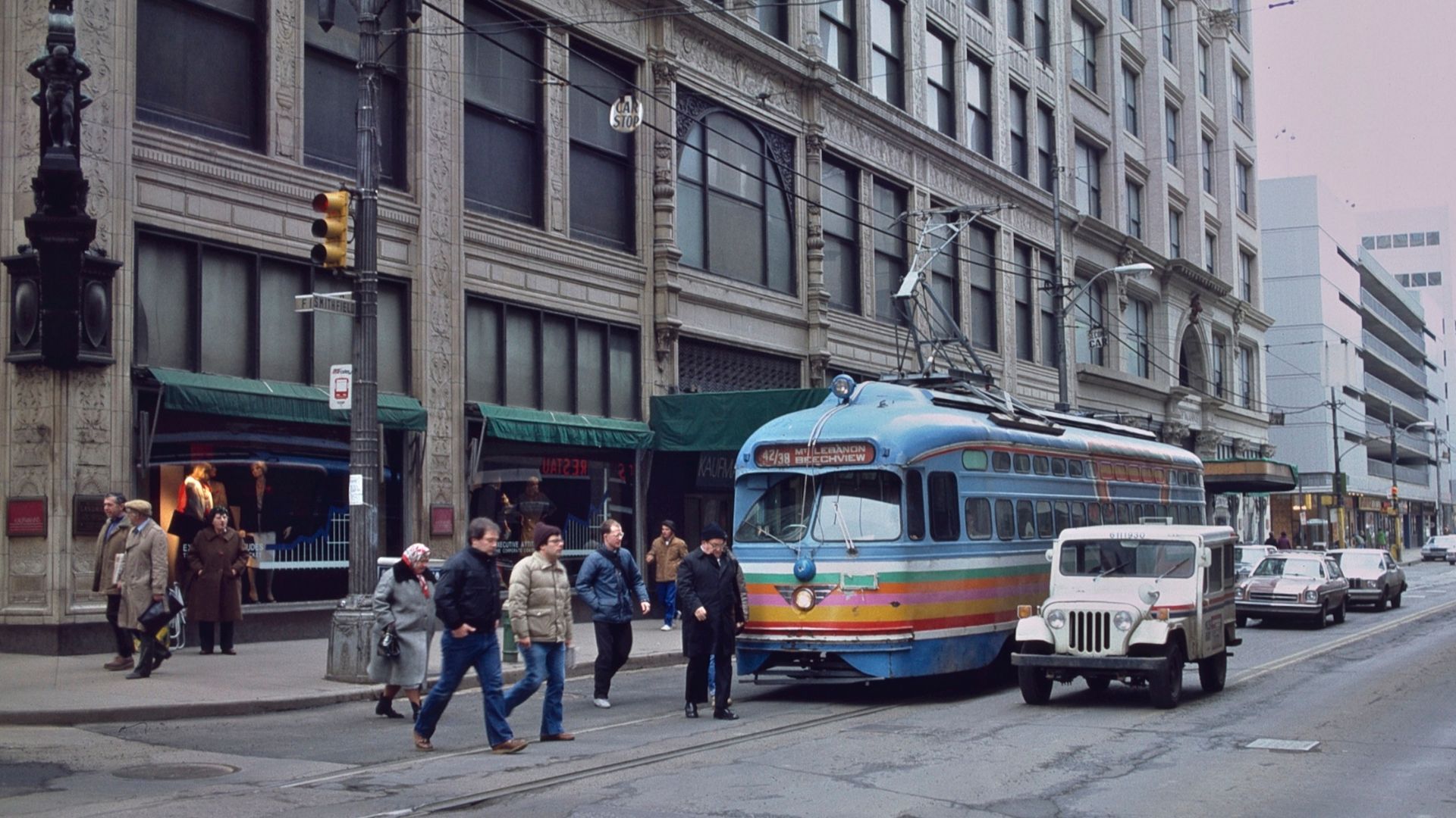 A trolley car/streetcar (tram) passing the flagship Kaufmann's store, in downtown Pittsburgh, in 1984.  The trolley (car No. 1754, wearing a paint scheme unique to that one car) was northbound on Smithfield Street at Fifth Avenue. The store became a Macy'