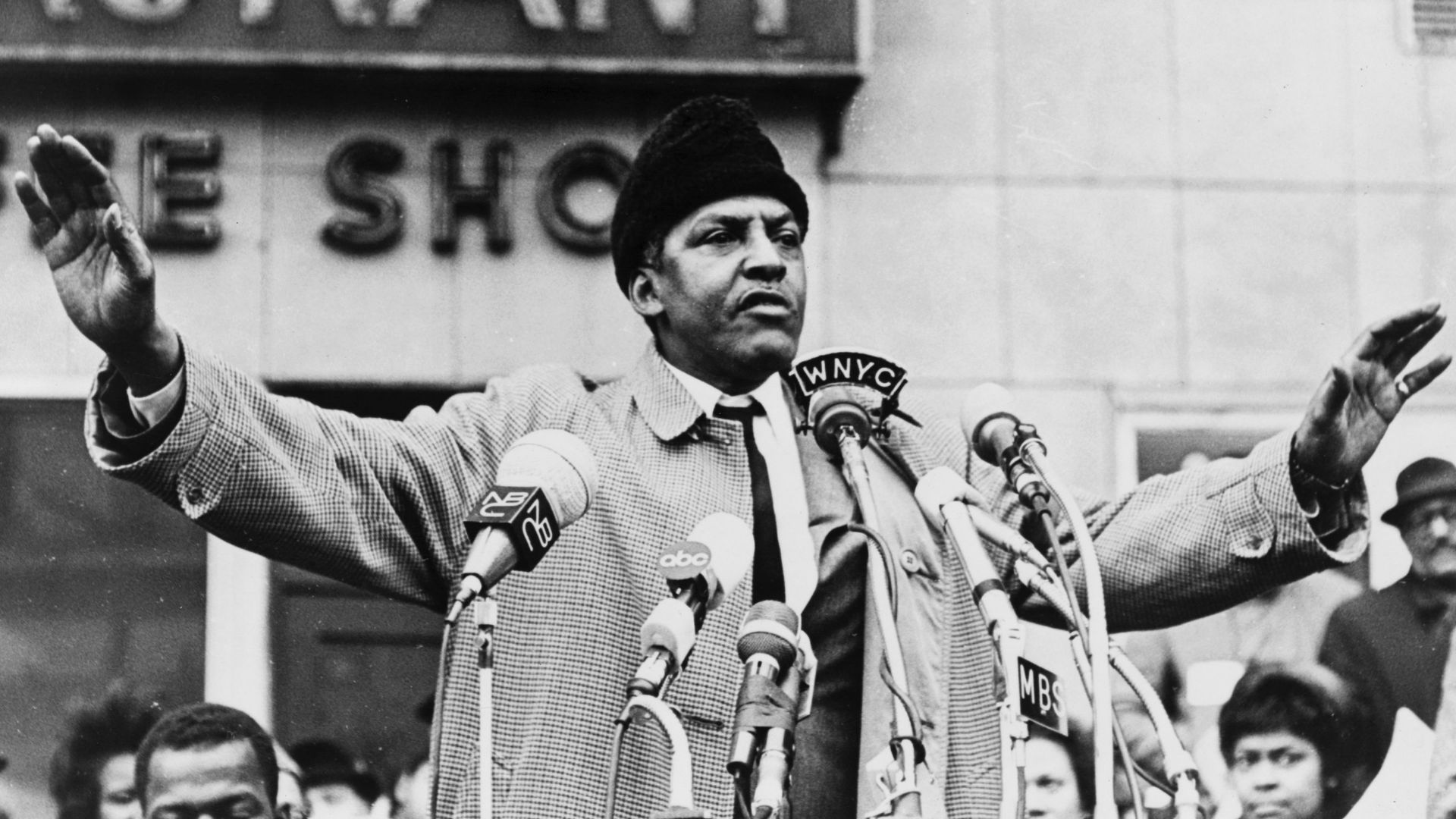 Bayard Rustin, half-length portrait, facing front, microphones in foreground  / World Telegram & Sun photo by Stanley Wolfson.