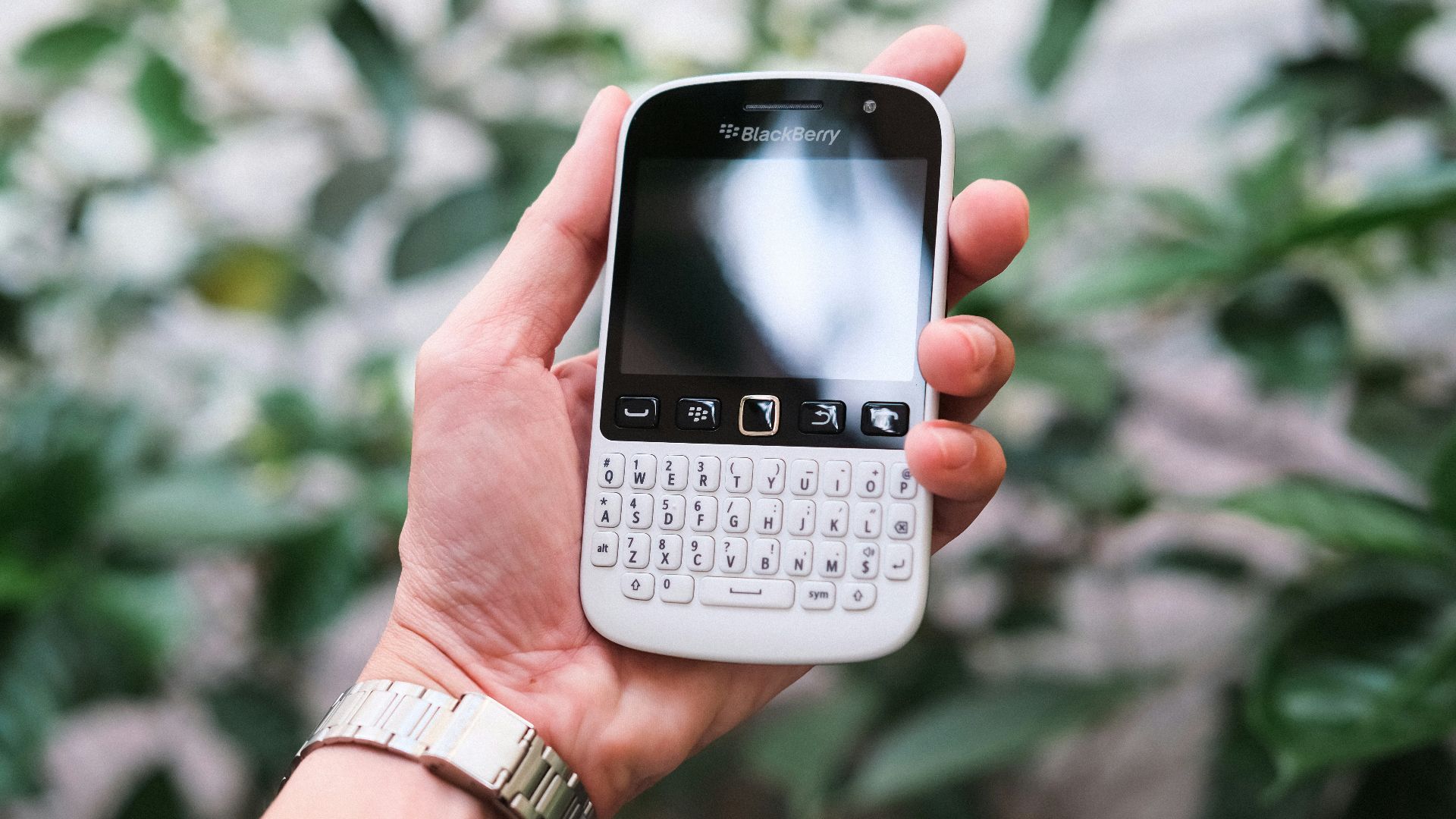 a person holding a smart phone in their hand