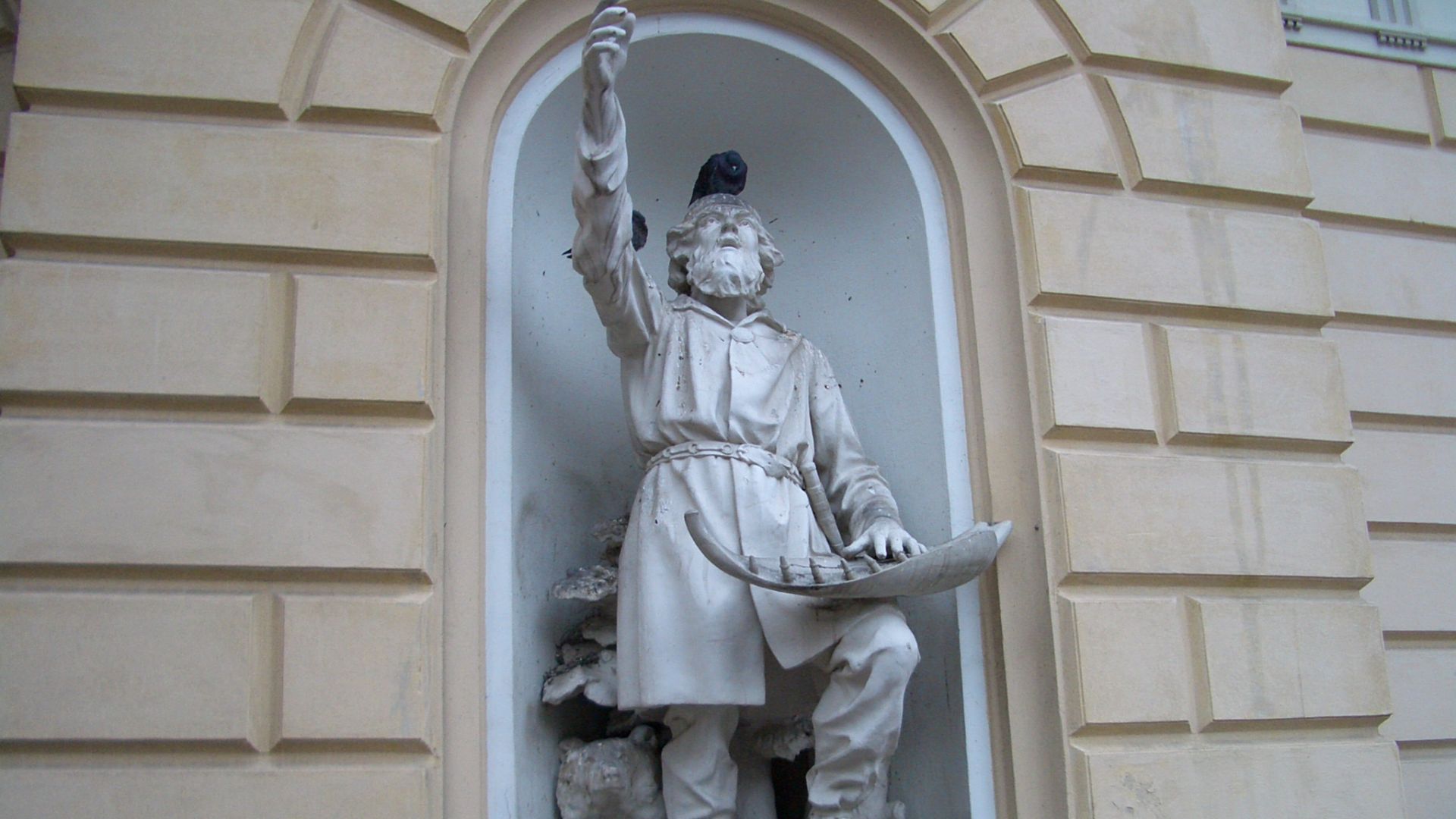 The statue of Väinämöinen (1888) by Robert Stigell (1852–1907) decorating the Vanha Ylioppilastalo (Old Studenthouse) built in 1870 in Helsinki, Finland. The legendary storyteller holds his kantele, made out of a giant pike's jawbone.