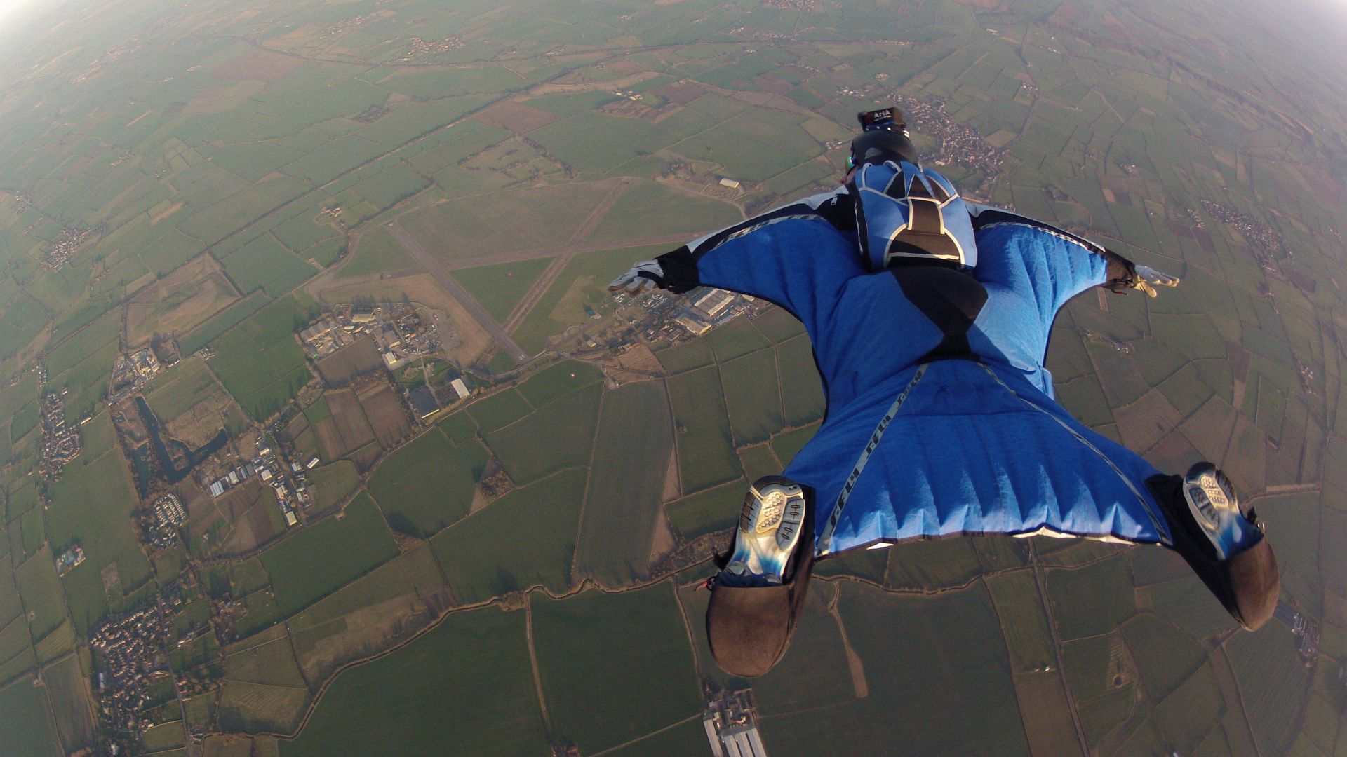 Wingsuit Flying over fields at Langar Airfield (Parachute/Skydive School) in the UK.