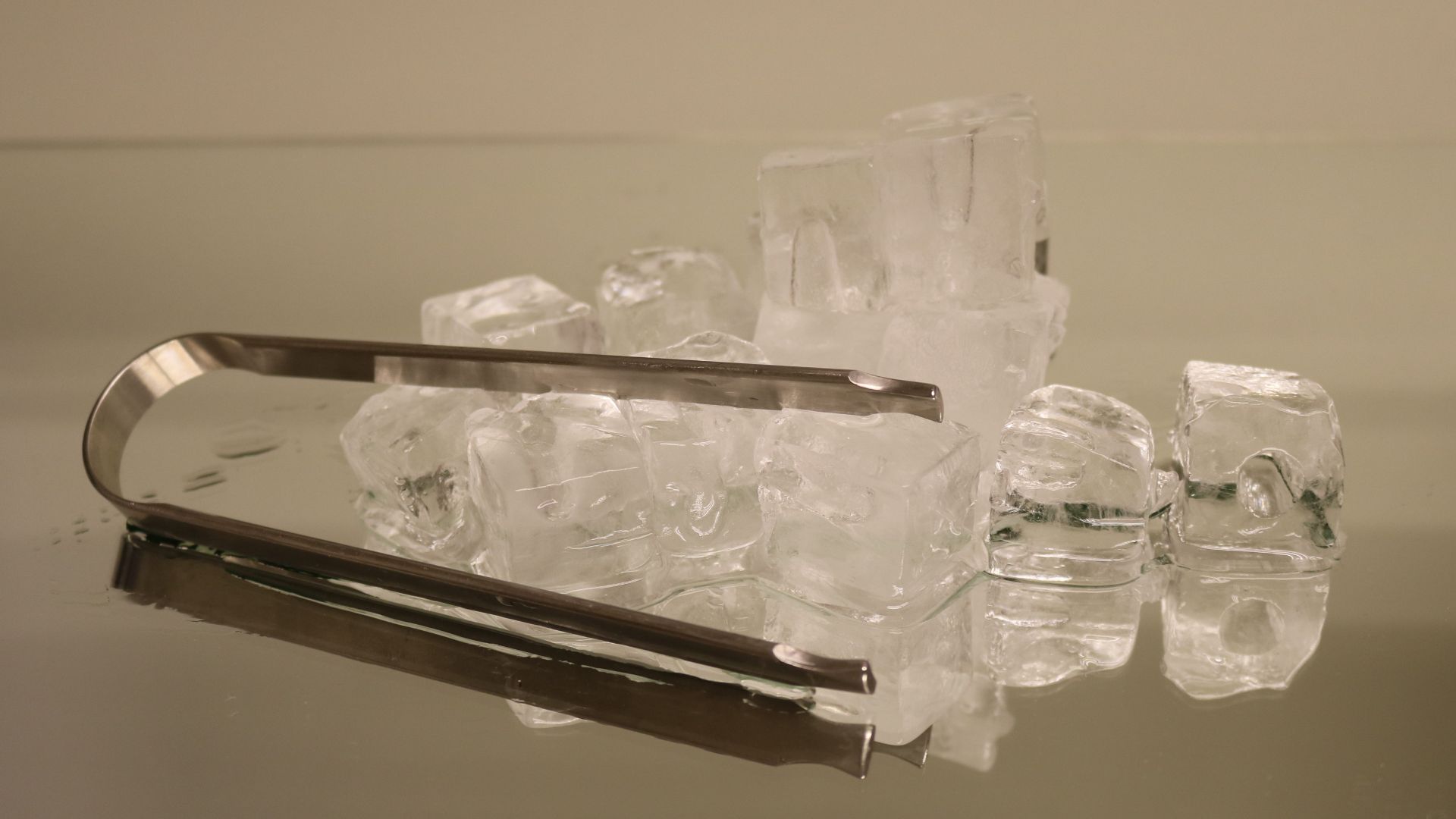 Ice cubes with ice tongs.