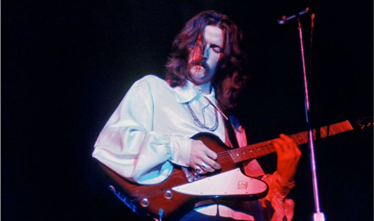 Eric Clapton with his guitar, eyes closed, long hair, both hands visible on his guitar. The Cream was indeed 