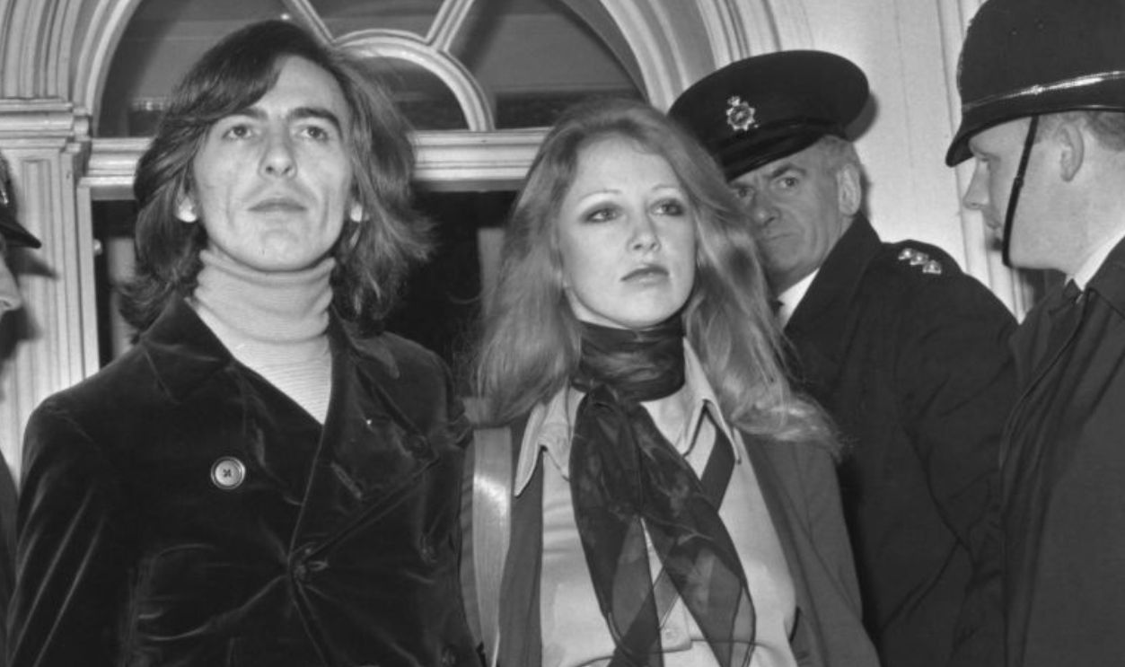 George Harrison (1943 - 2001) of the Beatles leaves Esher and Walton Magistrate's Court with his wife Pattie, after they appeared on charges of possessing cannabis, 18th March 1969.