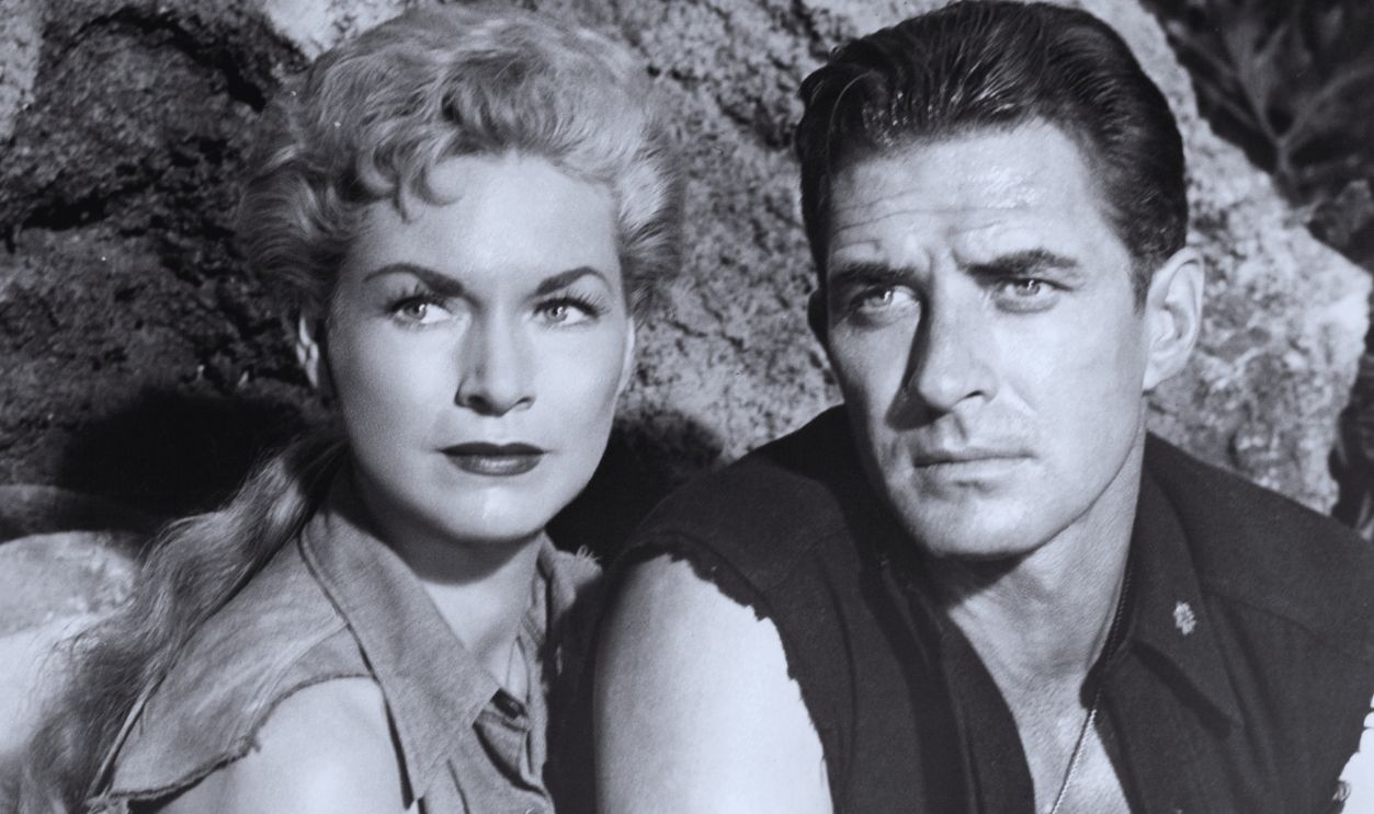 Gettyimages - 148257180, Shirley Patterson And Jock Mahoney In 'Land Of Unknown' Shirley Patterson and Jock Mahoney sitting near large rocks in a scene from the film 'Land Of Unknown', 1957.