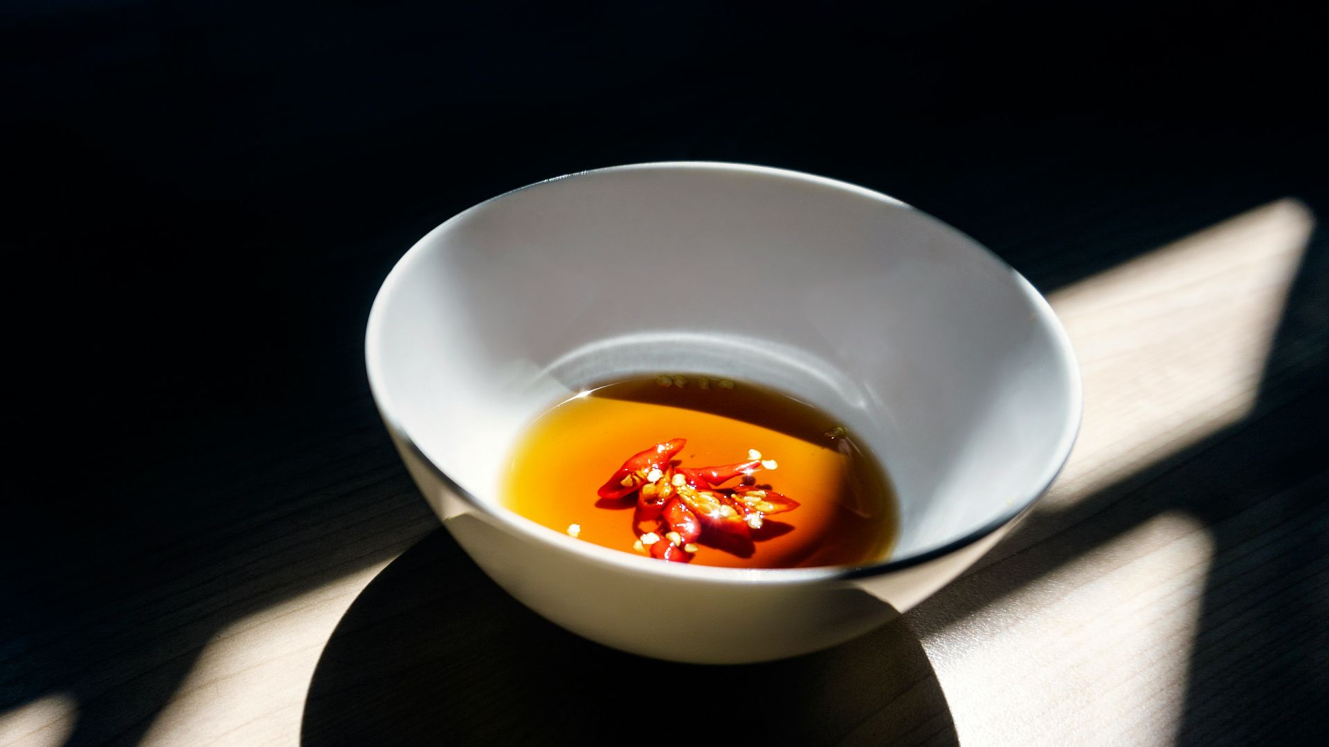 white ceramic bowl on wooden surface