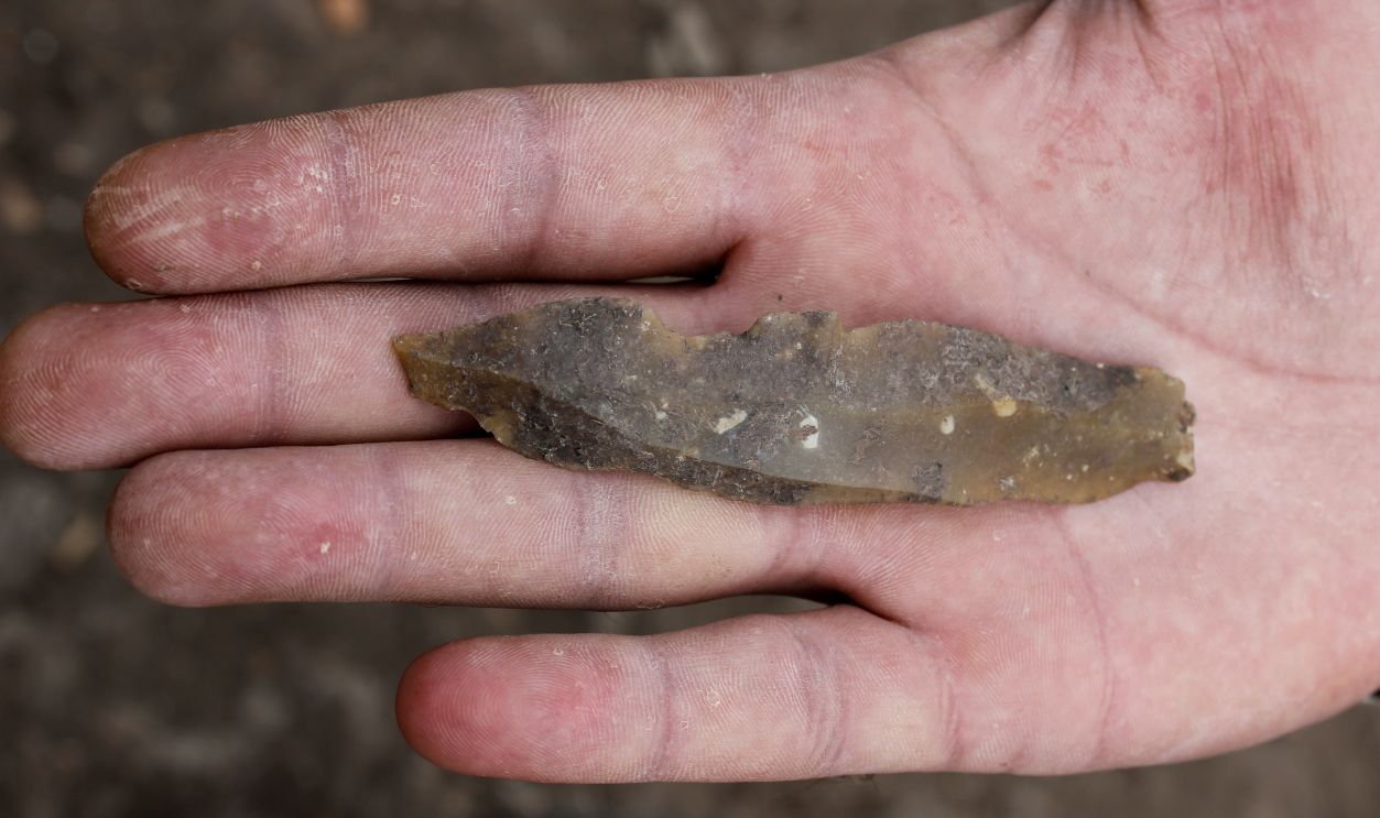 prehistoric flint artefact held in hand