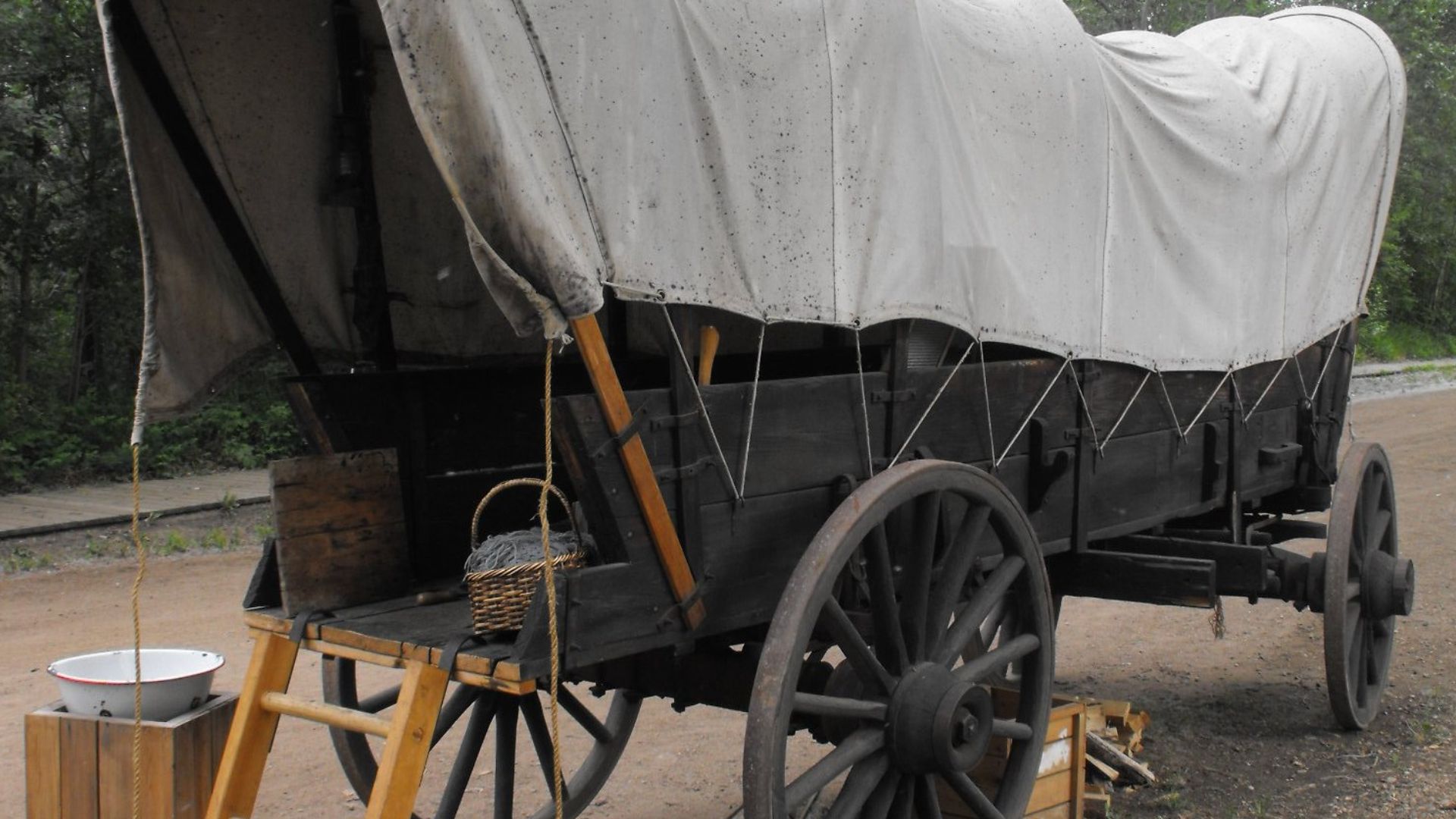 Narrow covered wagon of the type settlers used to transport goods and people west from Ontario via Winnipeg to Alberta, ca 1885. This photograph was made at Fort Edmonton Park, Edmonton, Alberta.