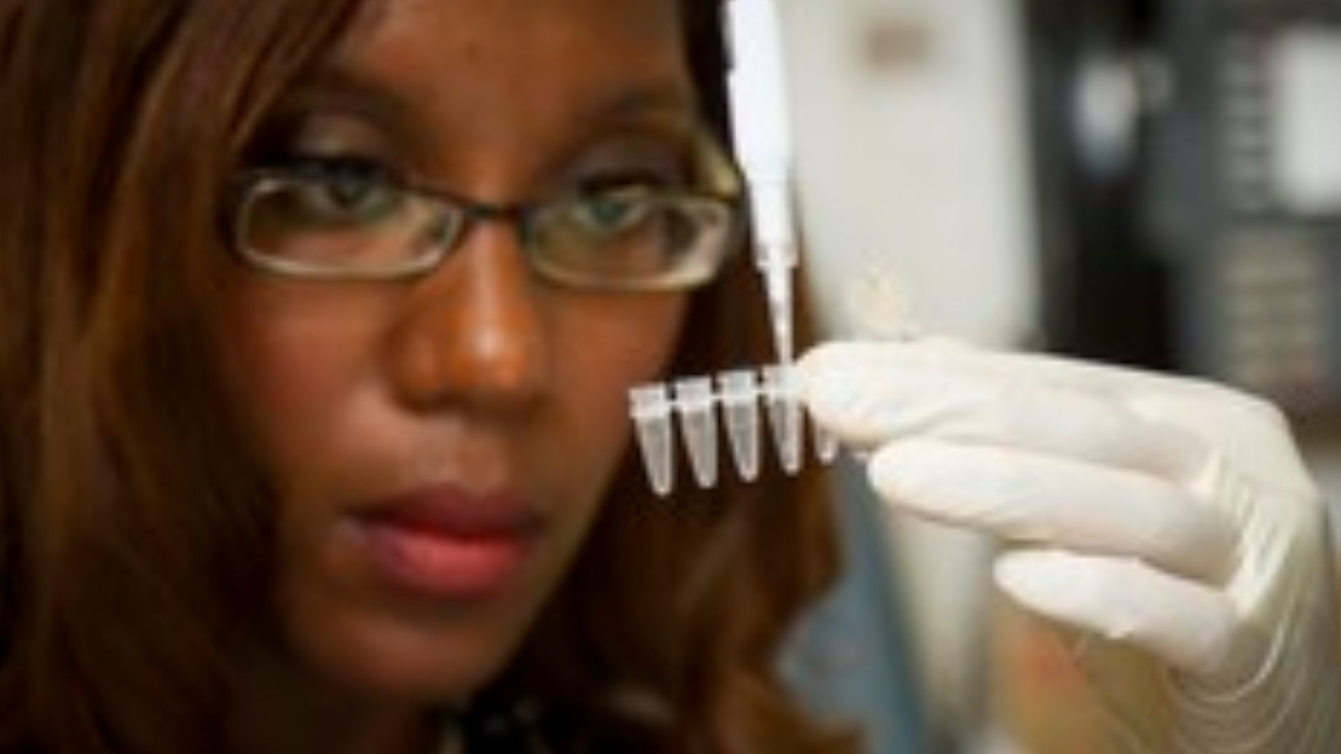 Chanelle Case Borden, Ph.D., a postdoctoral fellow in the National Cancer Institute's Experimental Immunology Branch, pipetting DNA samples into a tube for polymerase chain reaction, or PCR, a laboratory technique used to make multiple copies of a segment