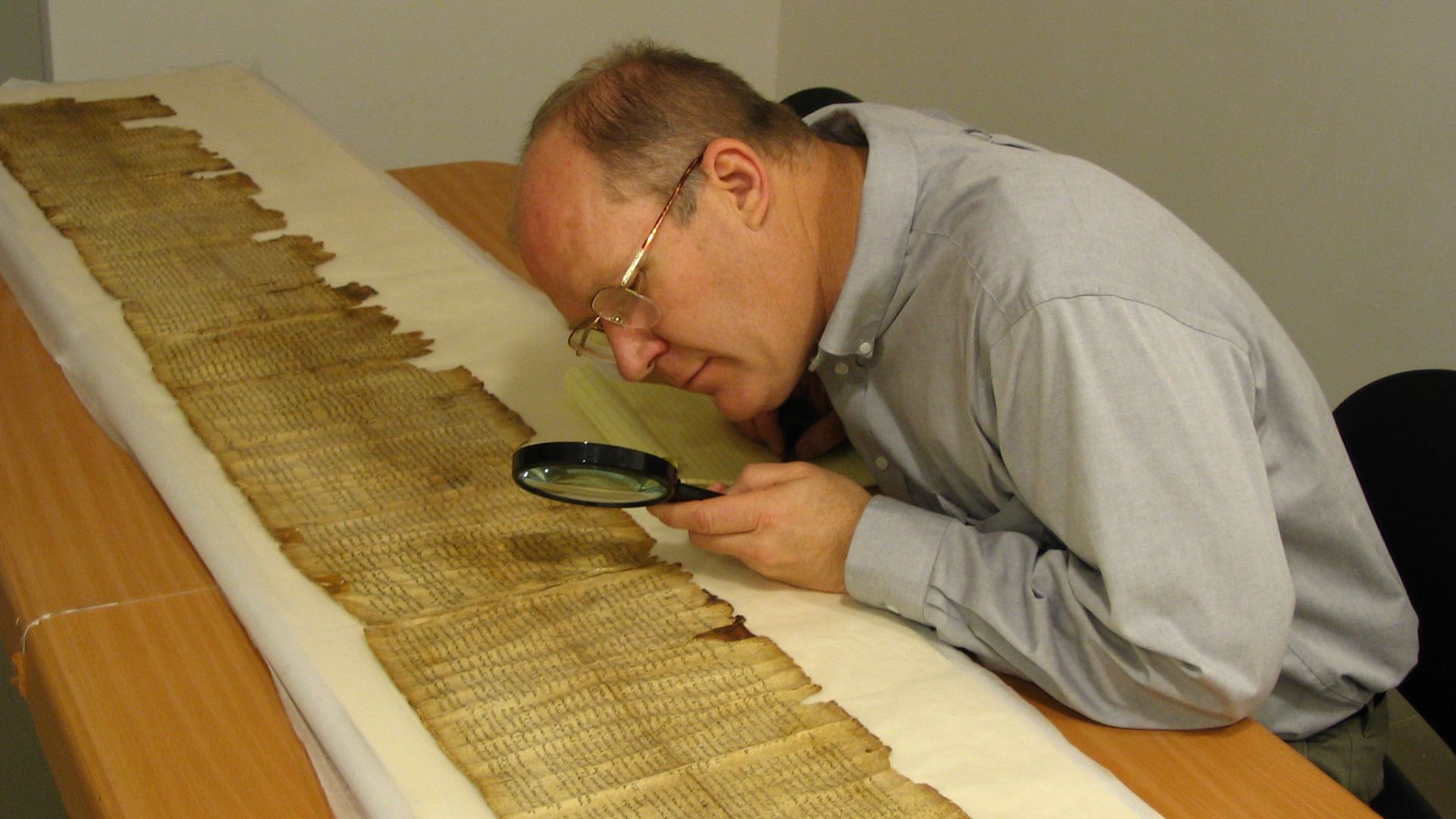 Parry studies the Great Isaiah Scroll (1QIsa-a) in the Dead Sea Scrolls vault (scrollery), Israeli Museum, Jerusalem, Israel.