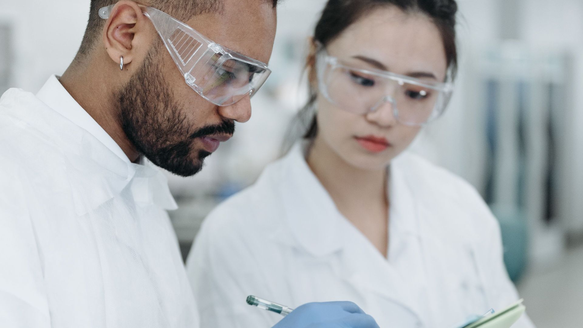 Two scientists working together in a laboratory, analyzing data and discussing results.
