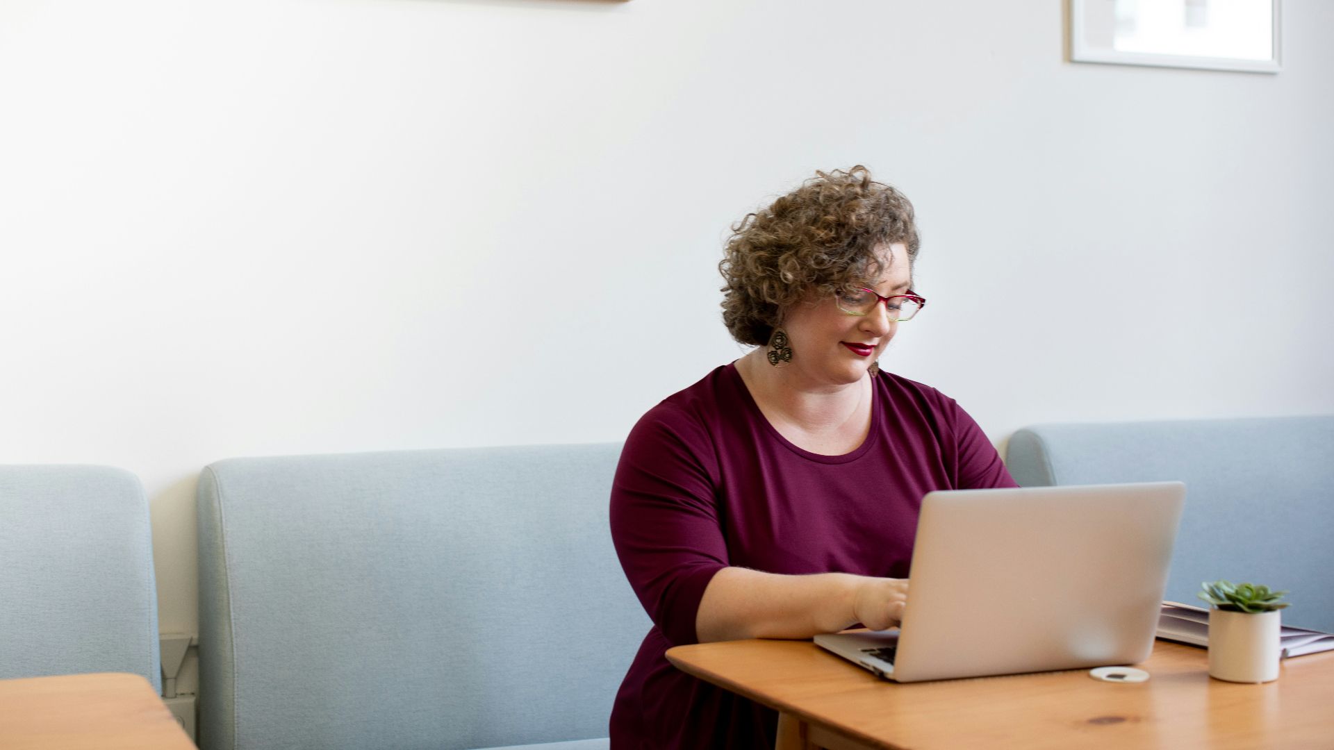 woman using laptop on desk