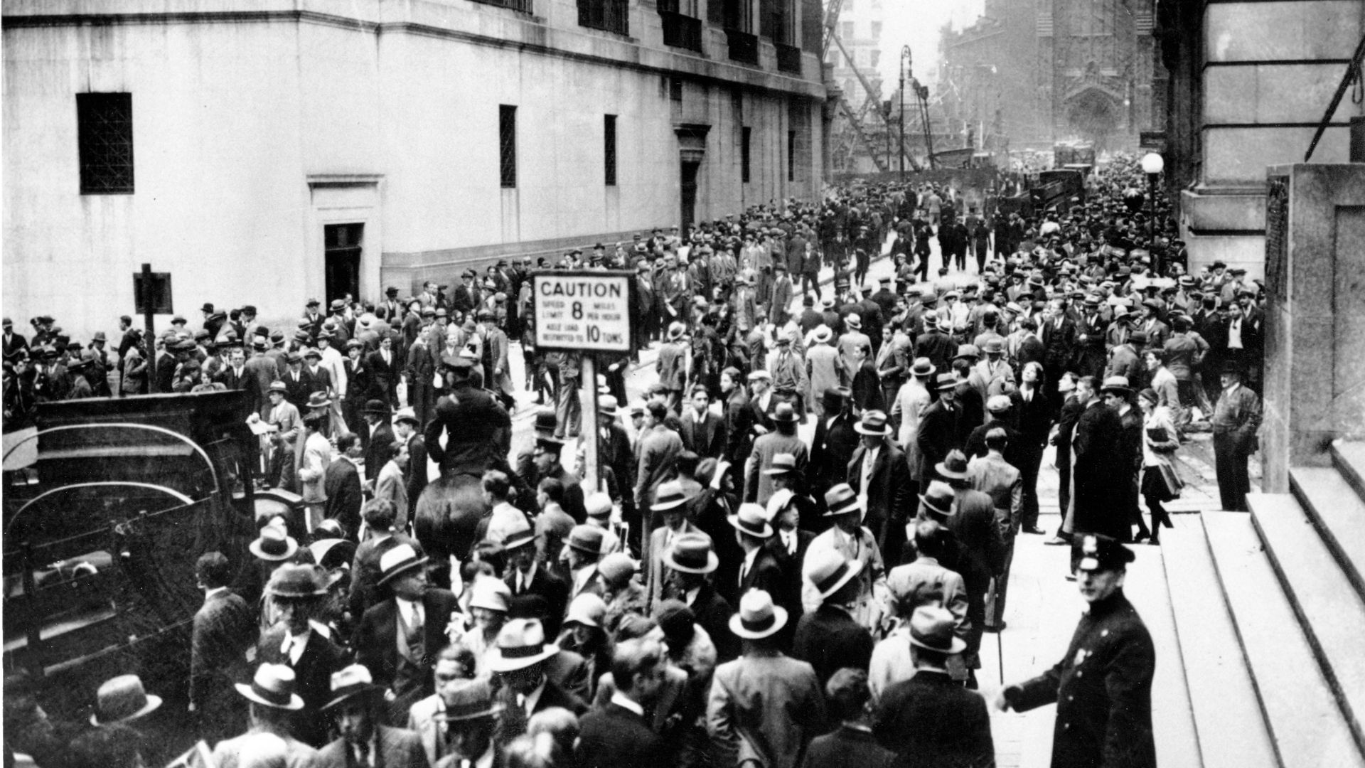 Crowds panic in the Wall Street district of Manhattan due to the heavy trading on the stock market in New York City on Oct. 24, 1929.