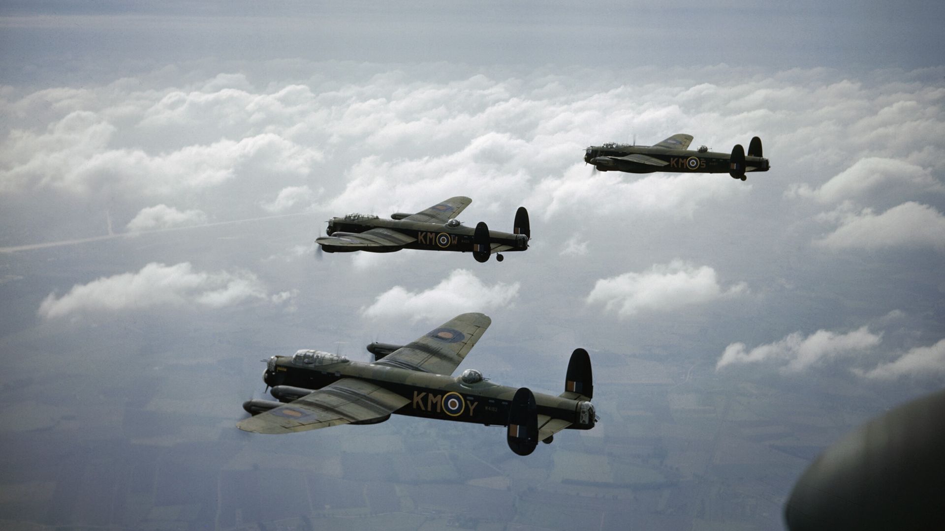 The Royal Air Force in Britain, 29 September 1942Three Avro Lancaster B Mark Is of No 44 Squadron, Royal Air Force based at Waddington, Lincolnshire, flying above the clouds.  Left to right: W4125,`KM-W' ('Weir'), being flown by Flight Sergeant Colin Wat